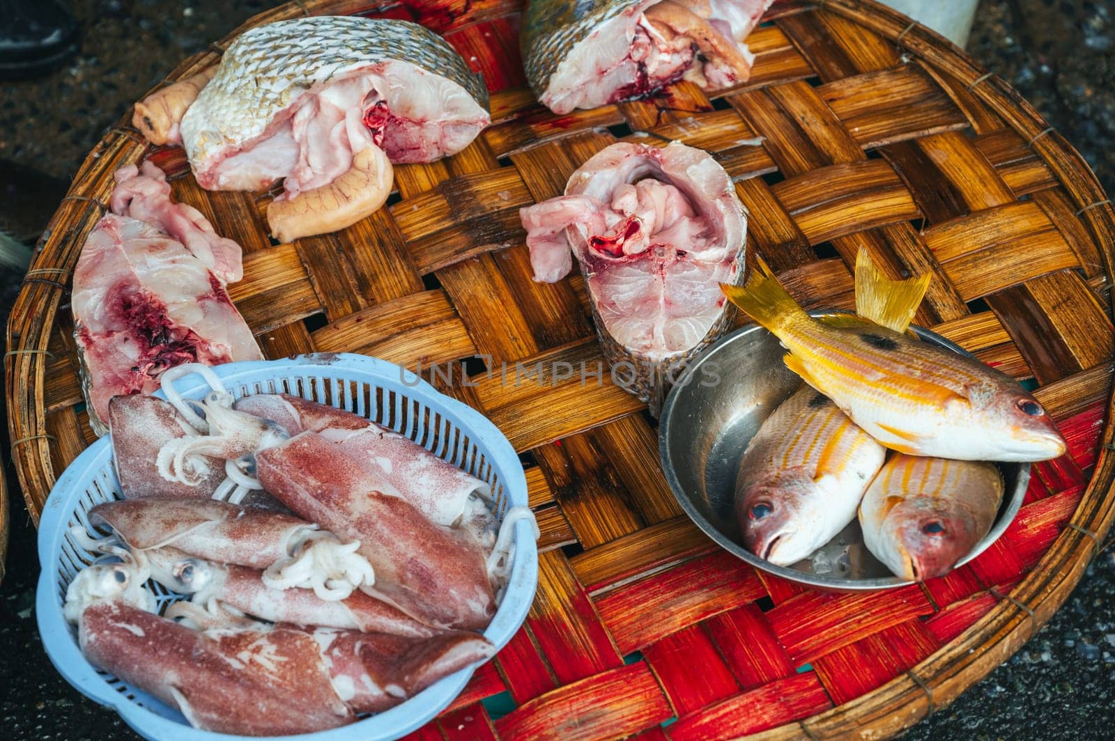 pieces of fresh fish and squid at the Asian street market in Asia in Vietnam