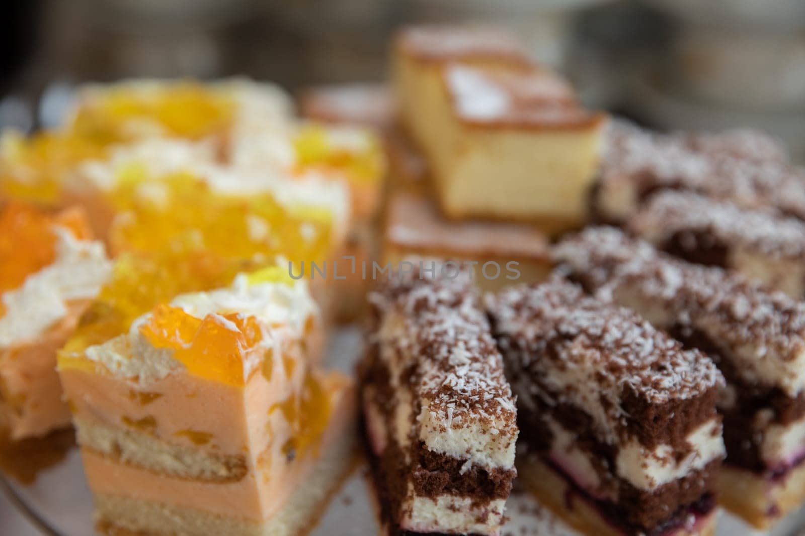 A tempting display of stunning layered cakes and sweet treats, ideal for any celebration or gathering