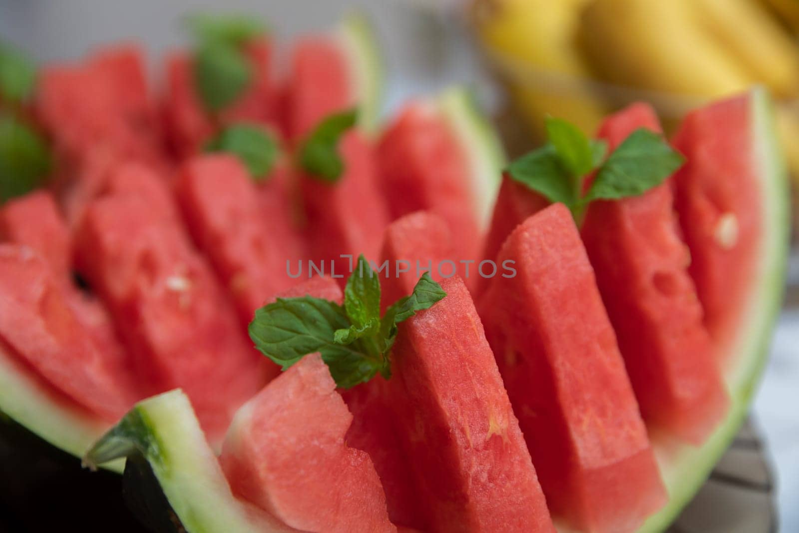 Refreshing slices of juicy watermelon adorned with fresh mint leaves, an ideal treat for summer recipes