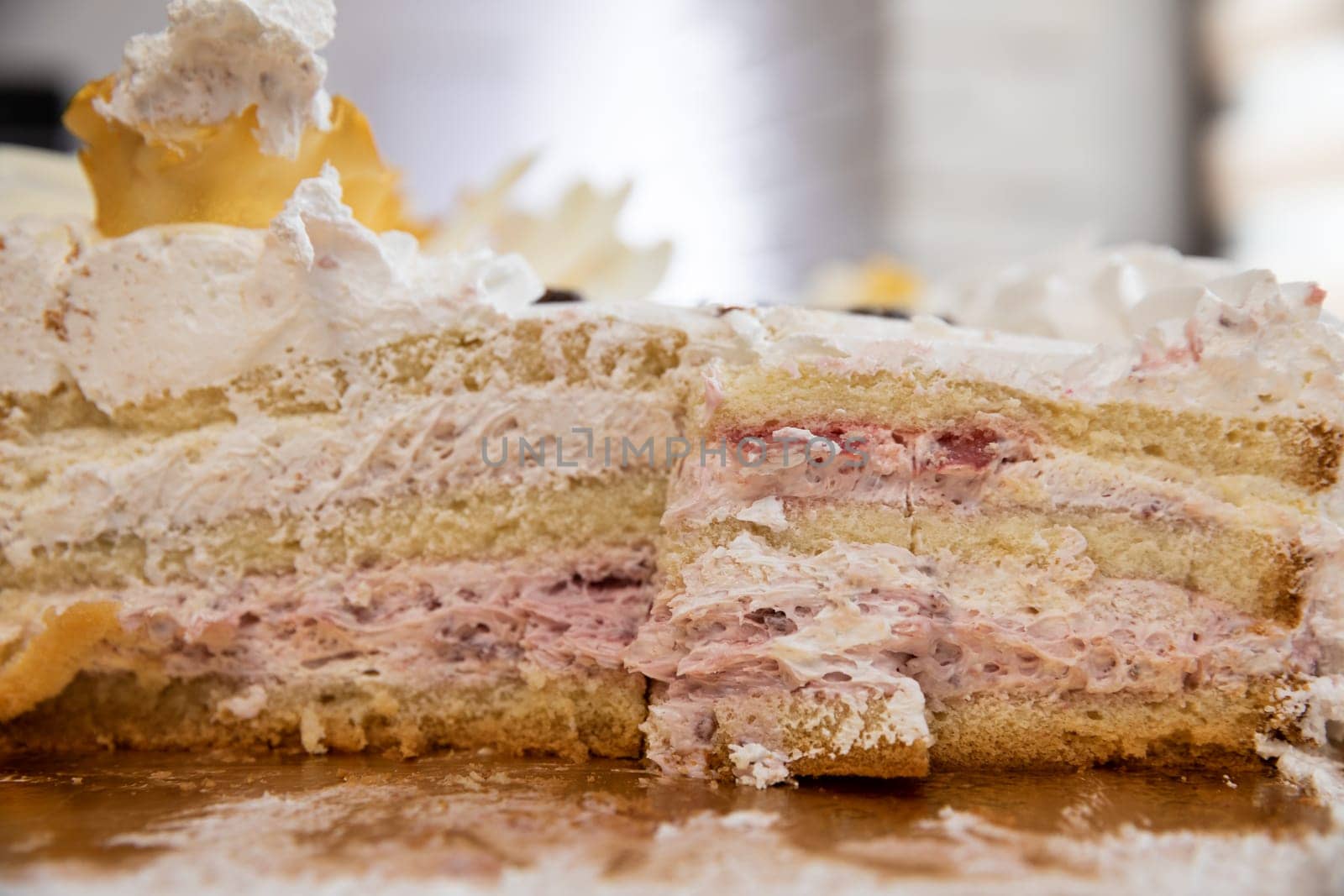 A beautiful close-up of a layered cake featuring cream and berry layers, perfect for dessert lovers.