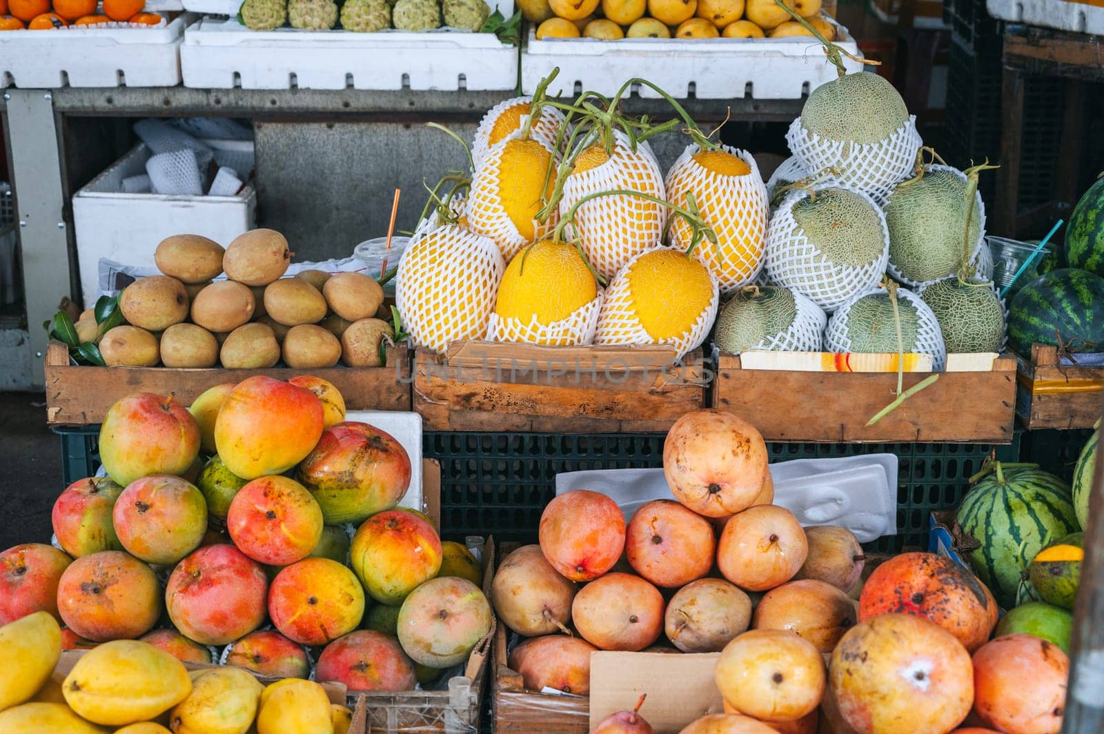 assortment of tropical exotic fruits at the Asian food market in Asia in Vietnam. Mango and Vietnamese ripe sweet fruits