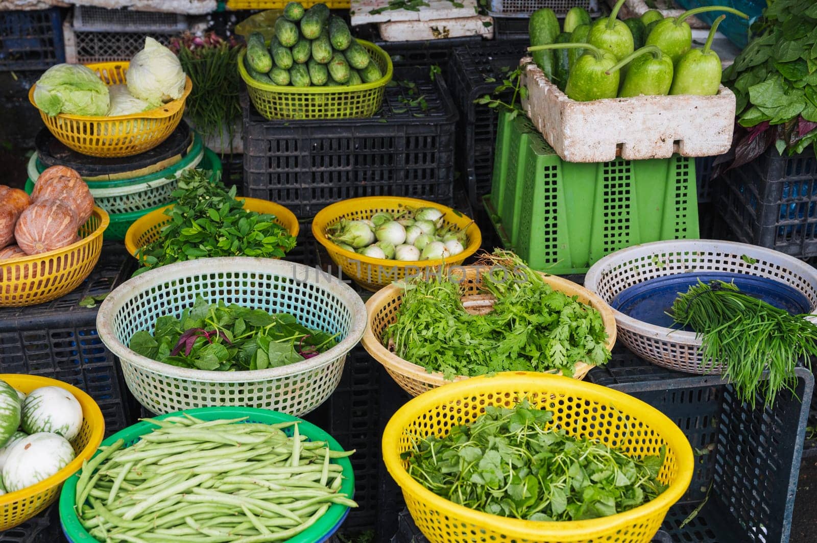 assortment of various vegetables and herbs at the street grocery and vegetable market in Asia in Vietnam