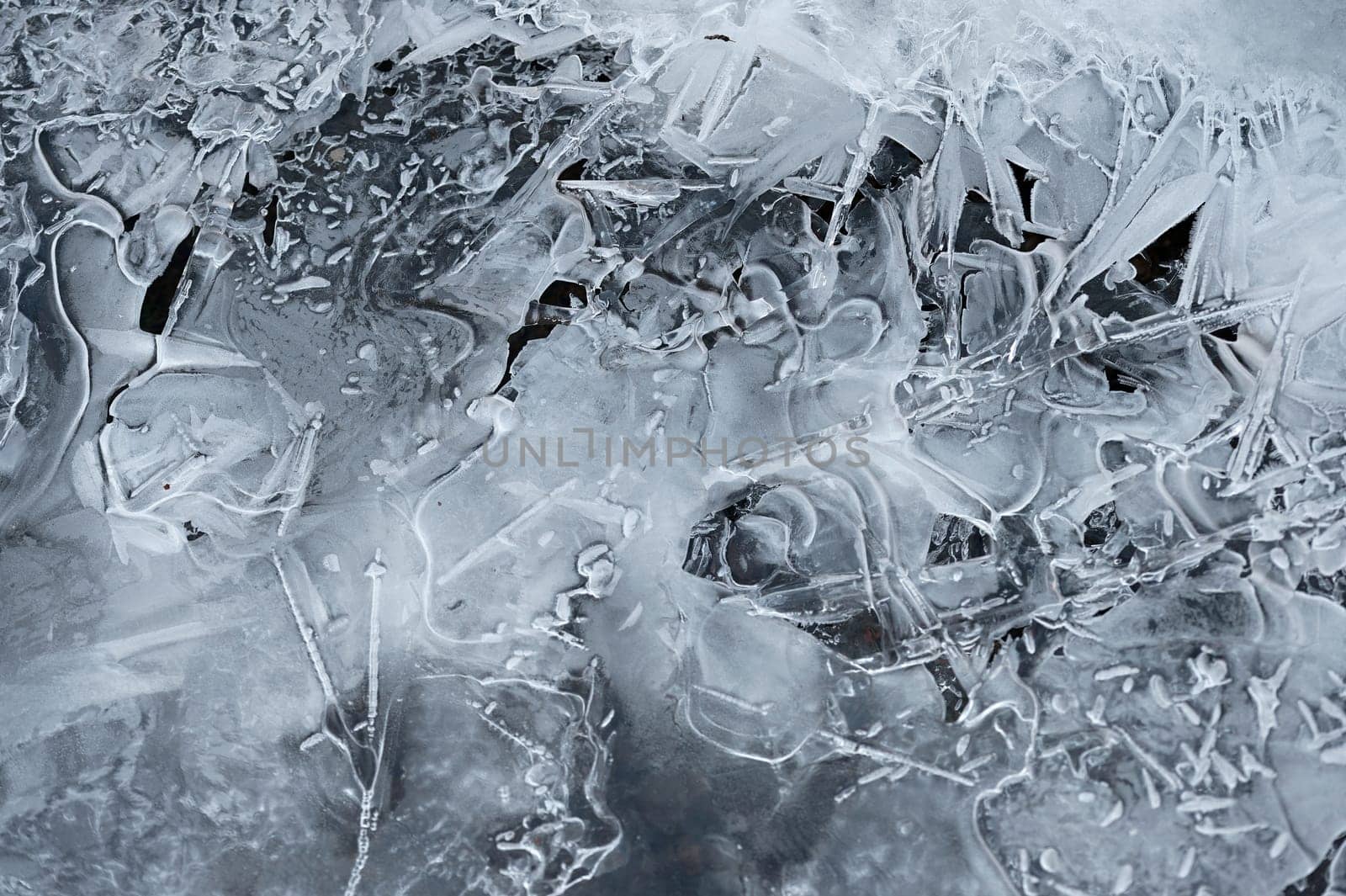 Frozen stream and ice closeup photo. Beautiful winter abstract background in nature. Concept for water and winter time