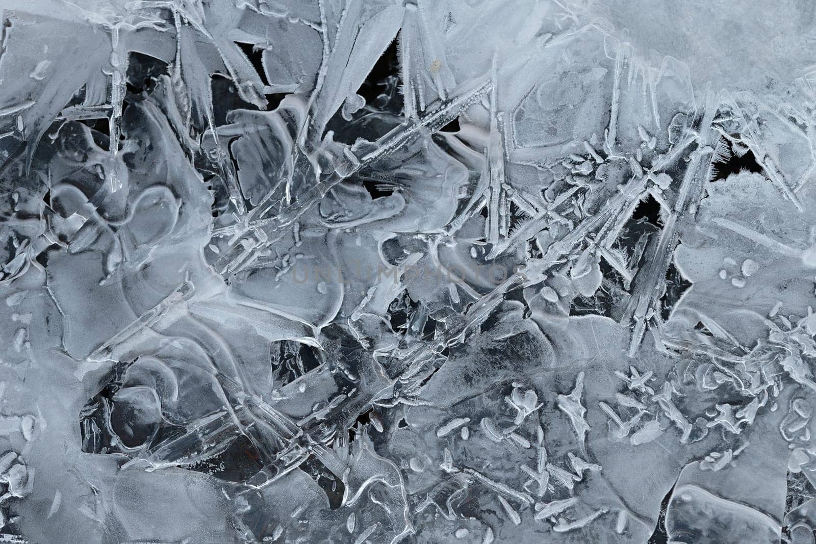 Frozen stream and ice closeup photo. Beautiful winter abstract background in nature. Concept for water and winter time