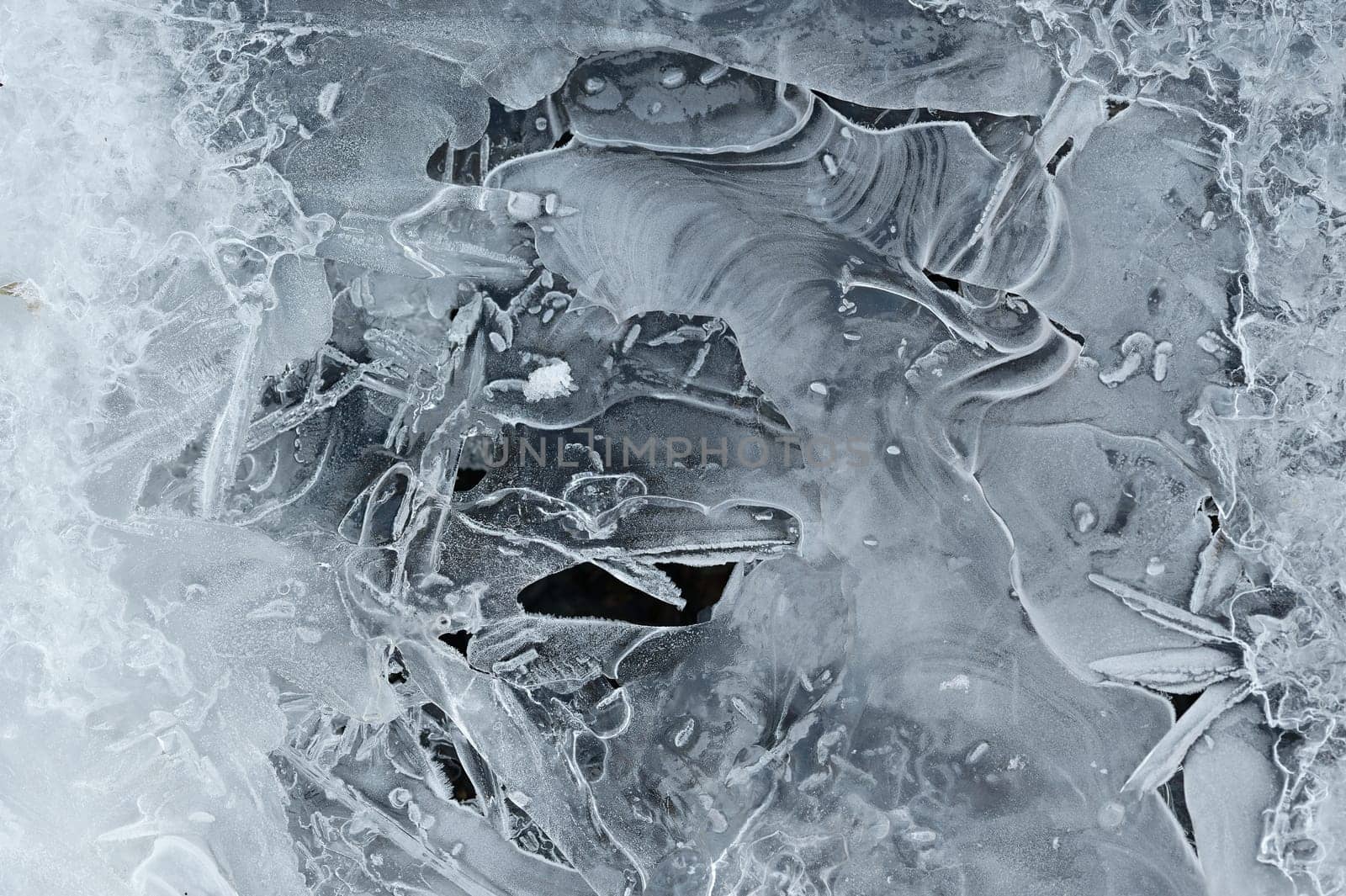 Frozen stream and ice closeup photo. Beautiful winter abstract background in nature. Concept for water and winter time