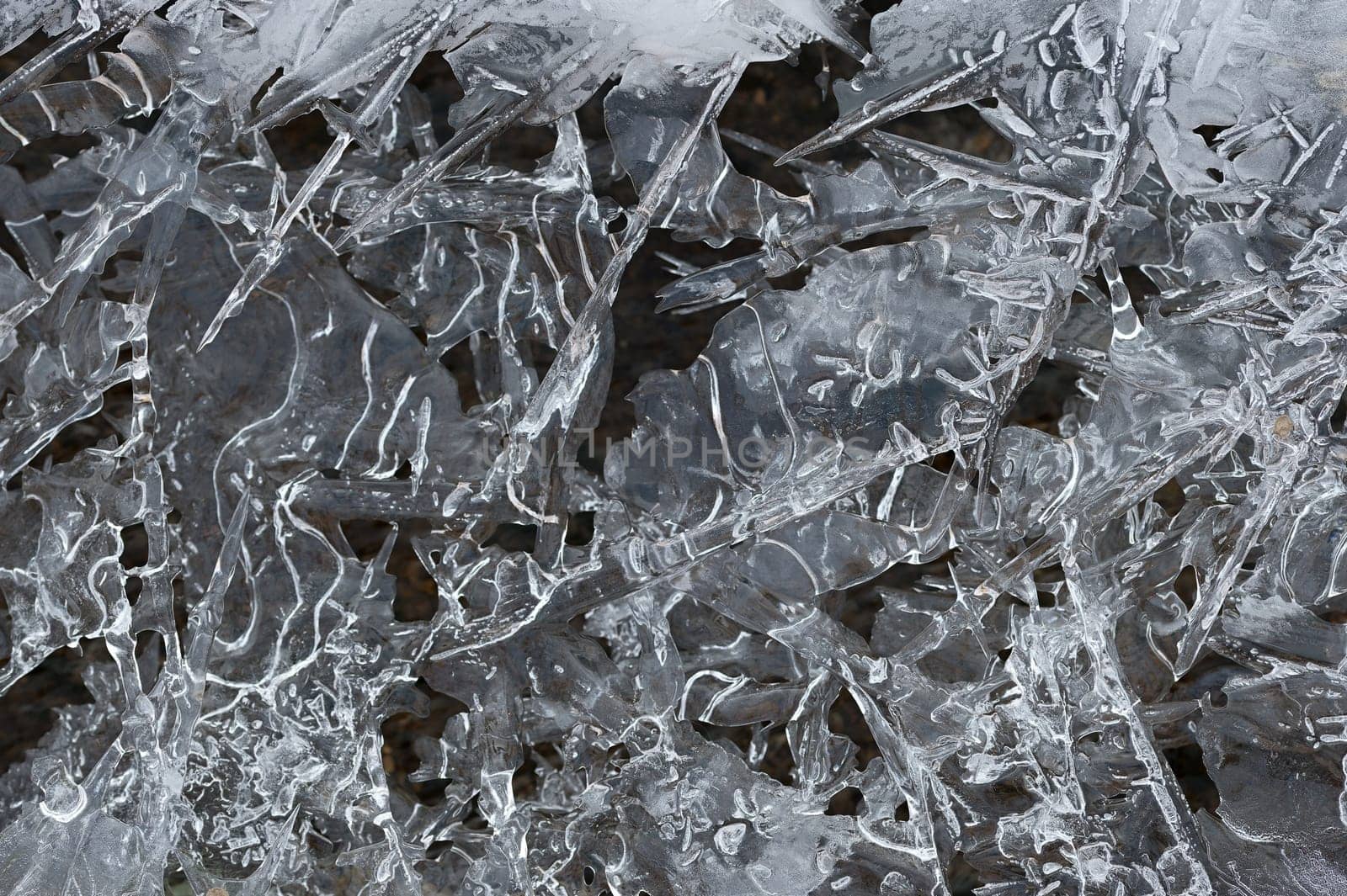 Frozen stream and ice closeup photo. Beautiful winter abstract background in nature. Concept for water and winter time