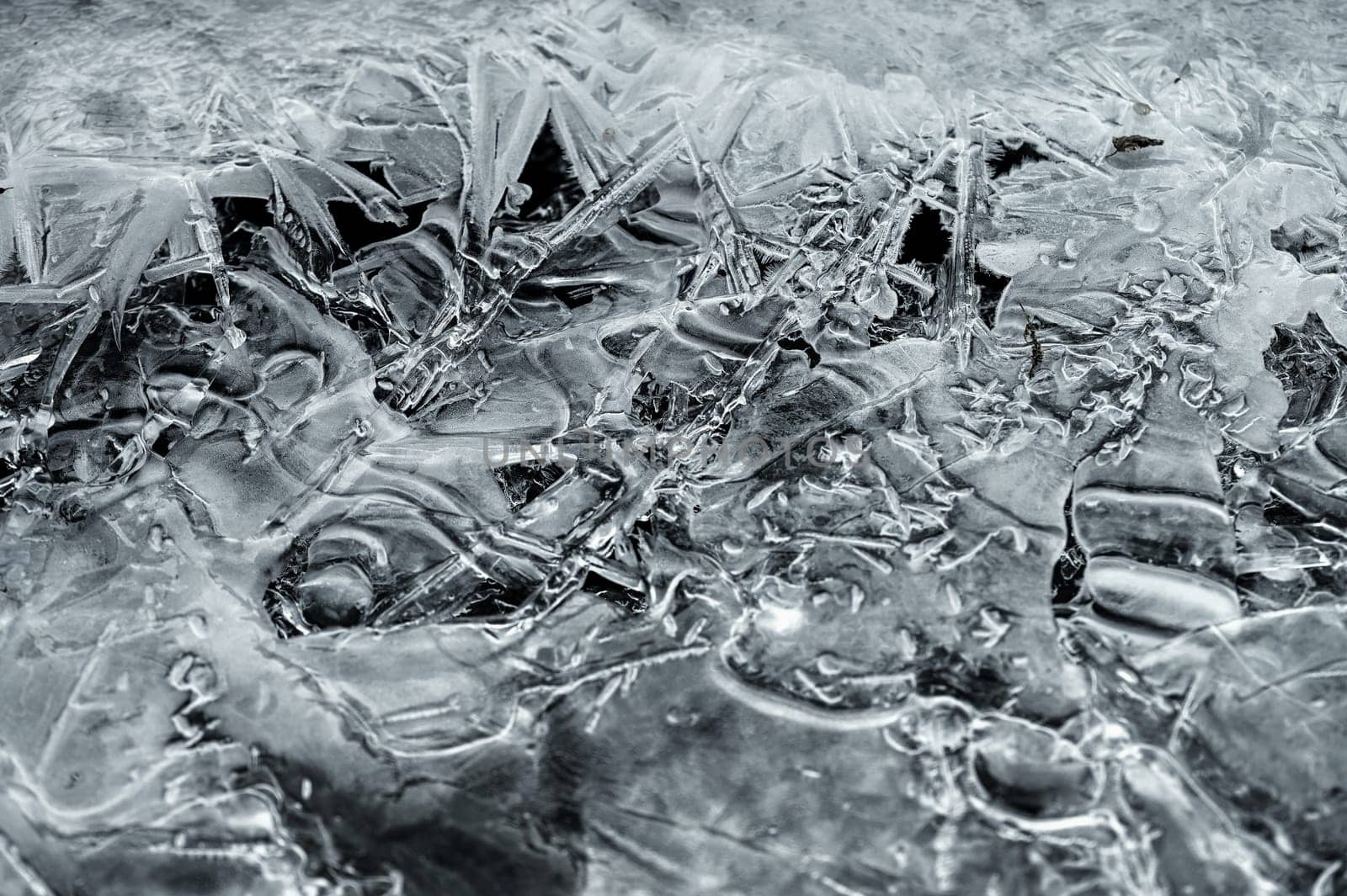 Frozen stream and ice closeup photo. Beautiful winter abstract background in nature. Concept for water and winter time