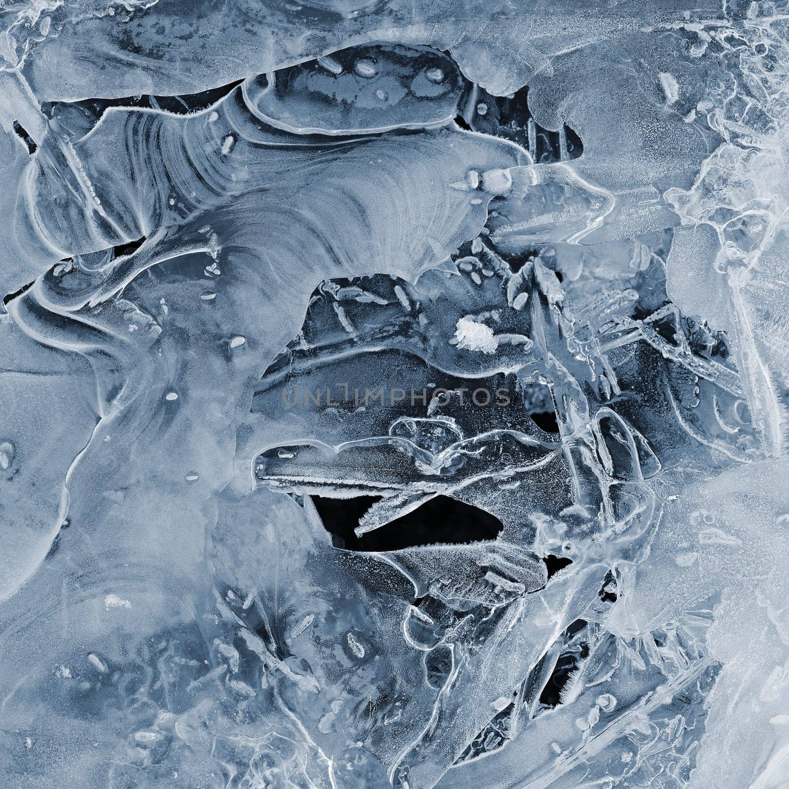 Frozen stream and ice closeup photo. Beautiful winter abstract background in nature. Concept for water and winter time