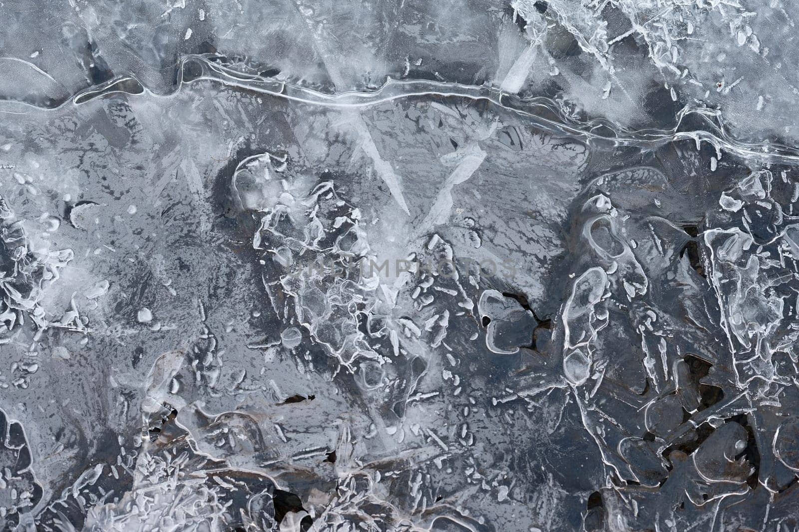 Frozen stream and ice closeup photo. Beautiful winter abstract background in nature. Concept for water and winter time