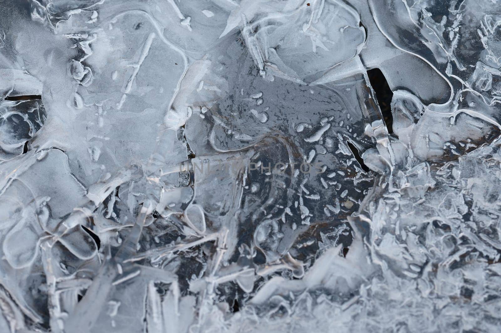 Frozen stream and ice closeup photo. Beautiful winter abstract background in nature. Concept for water and winter time