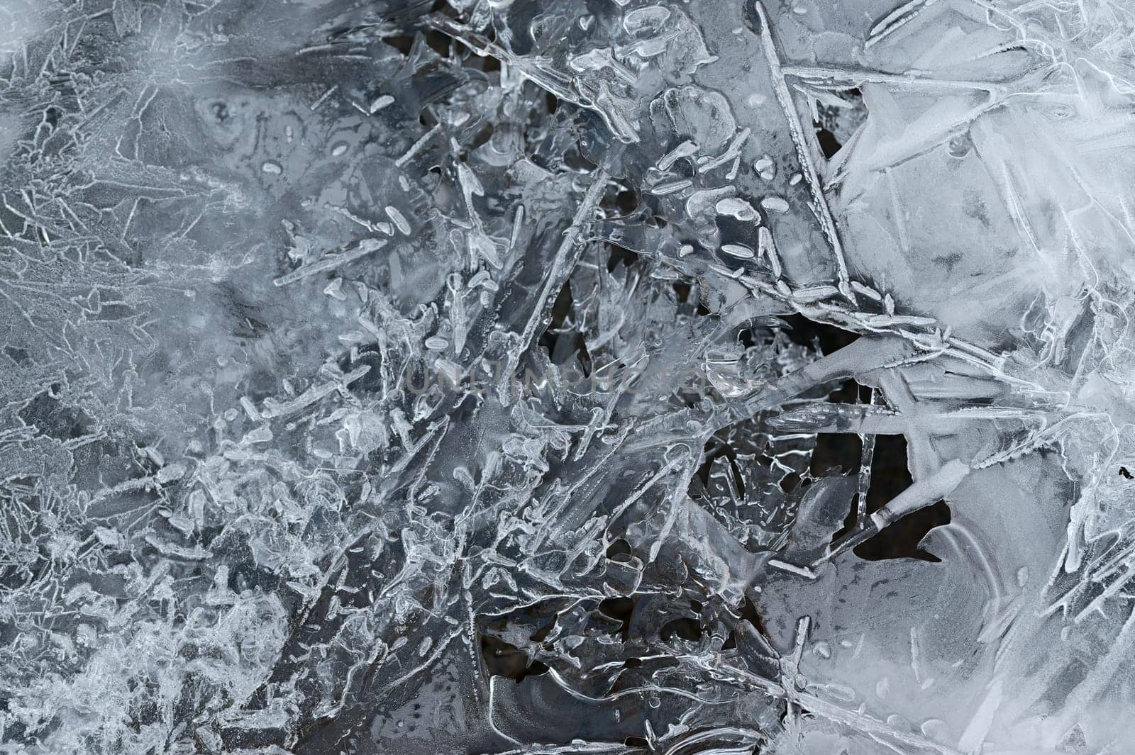 Frozen stream and ice closeup photo. Beautiful winter abstract background in nature. Concept for water and winter time