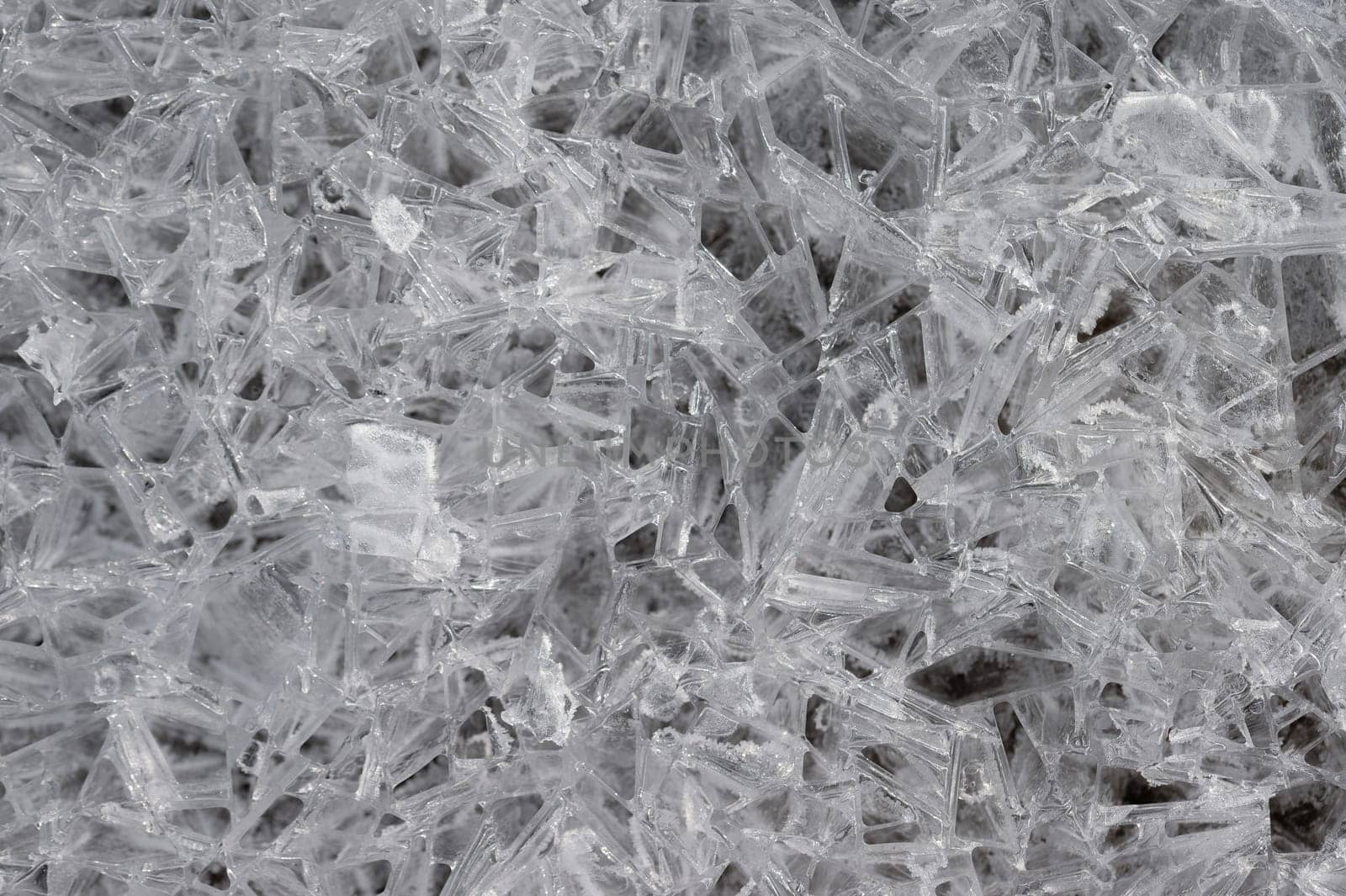 Frozen stream and ice closeup photo. Beautiful winter abstract background in nature. Concept for water and winter time