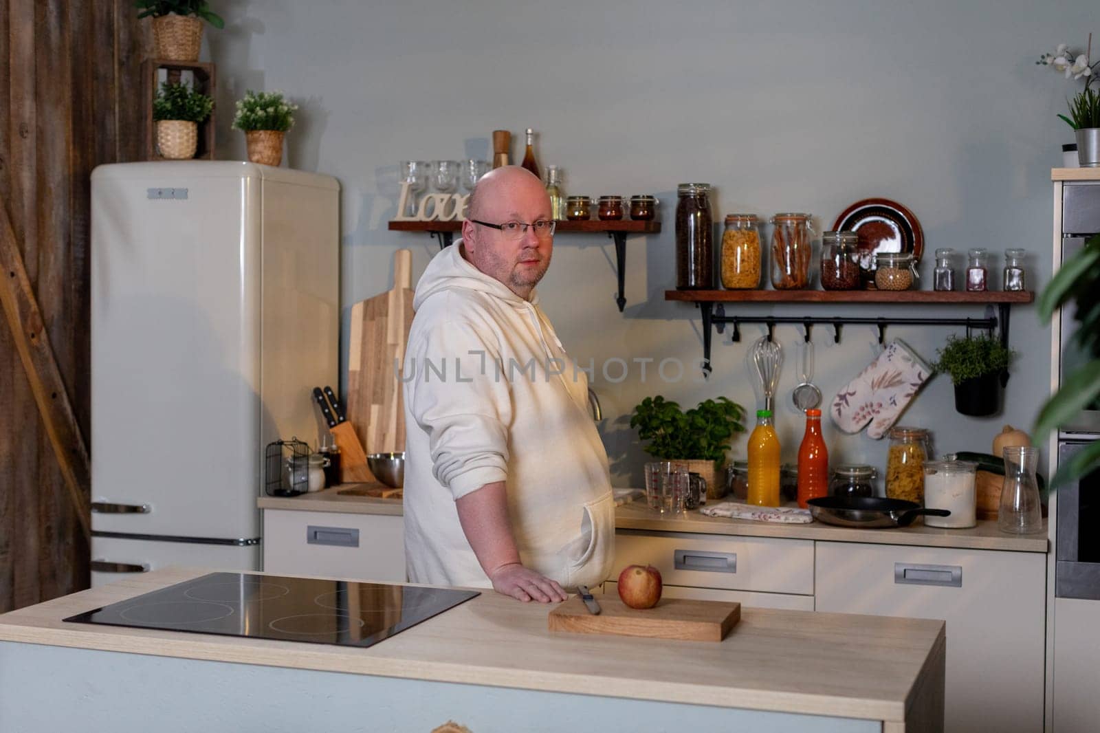 In a cozy, welcoming kitchen, a skilled chef eagerly prepares fresh, vibrant vegetables on a sturdy wooden countertop