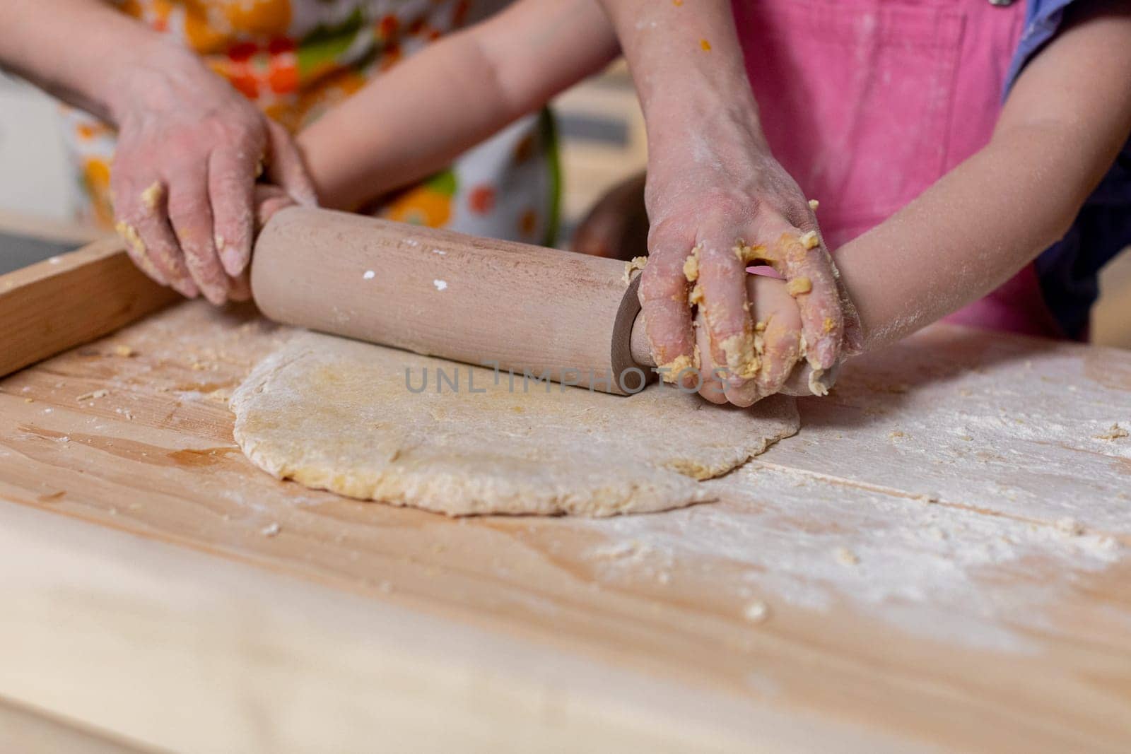 A truly joyful moment of family bonding occurs while rolling out dough in the kitchen together, creating memories