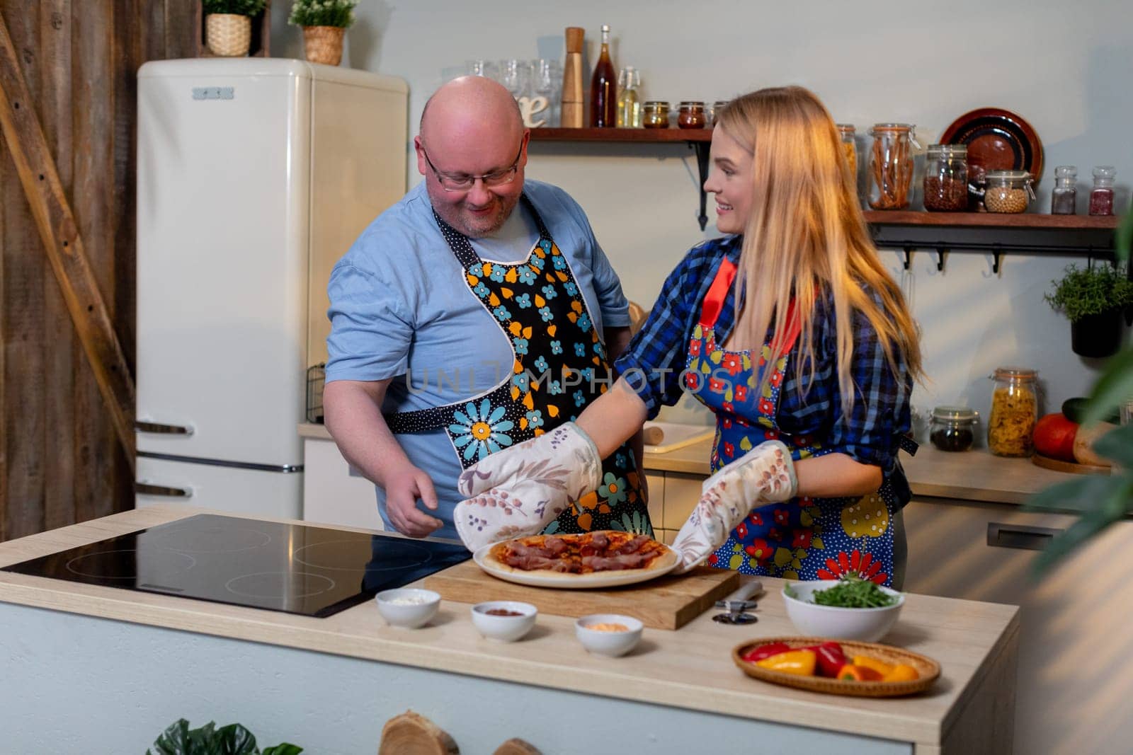 A delightful and joyful cooking scene featuring two people joyfully preparing delicious food together as a team