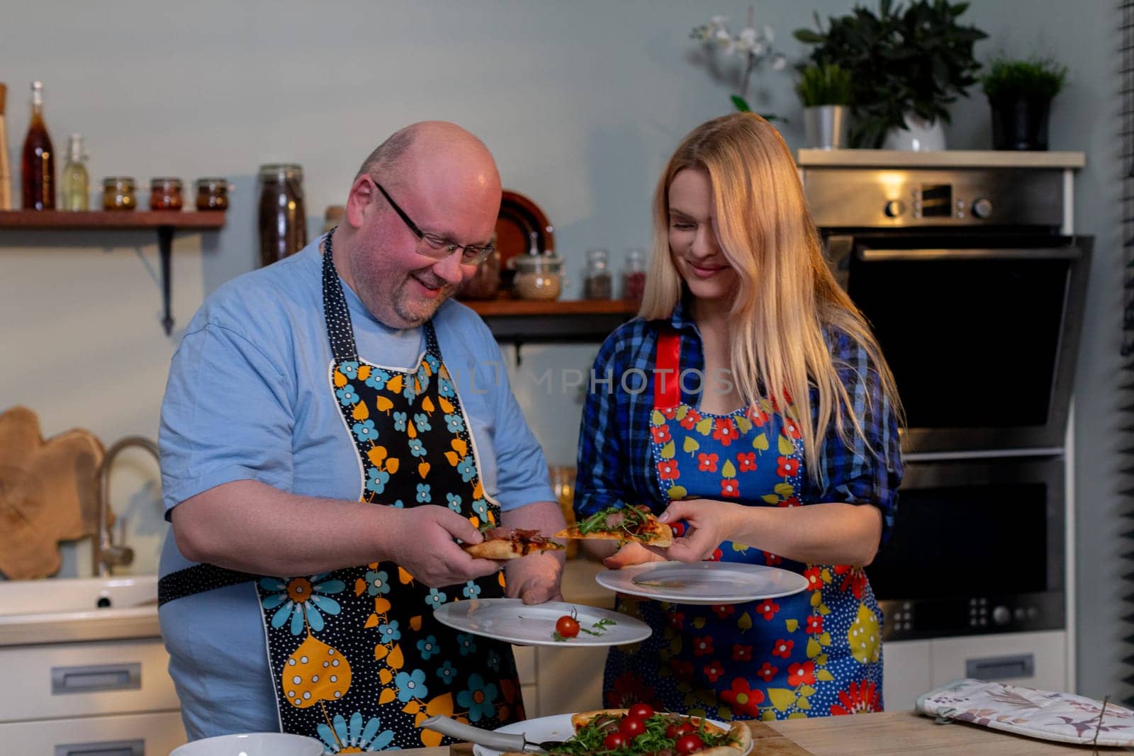 A cheerful duo prepares a delicious meal together, showcasing their teamwork and creativity in the kitchen
