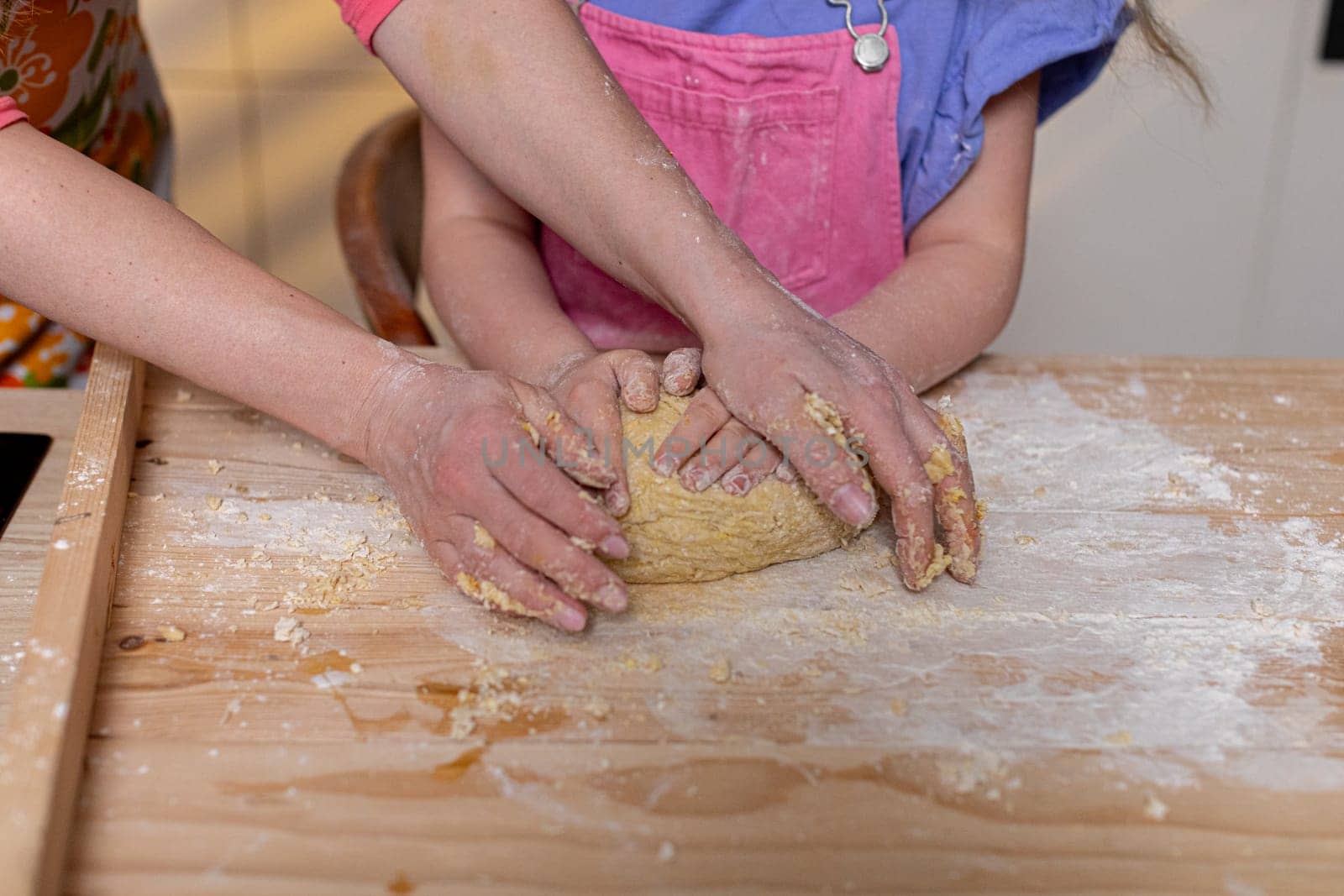 A joyful moment of hands skillfully kneading fresh dough, embodying family cooking time filled with creativity and love