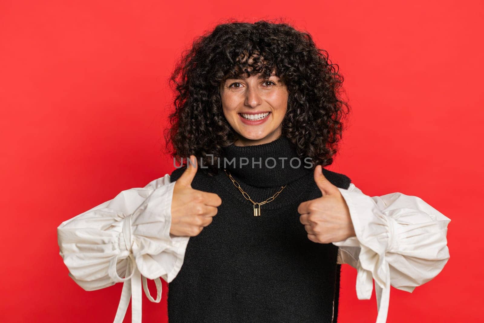 Like. Caucasian woman raises thumbs up agrees with something or gives positive reply recommends advertisement likes good idea feedback celebrating success victory. Girl isolated on red background