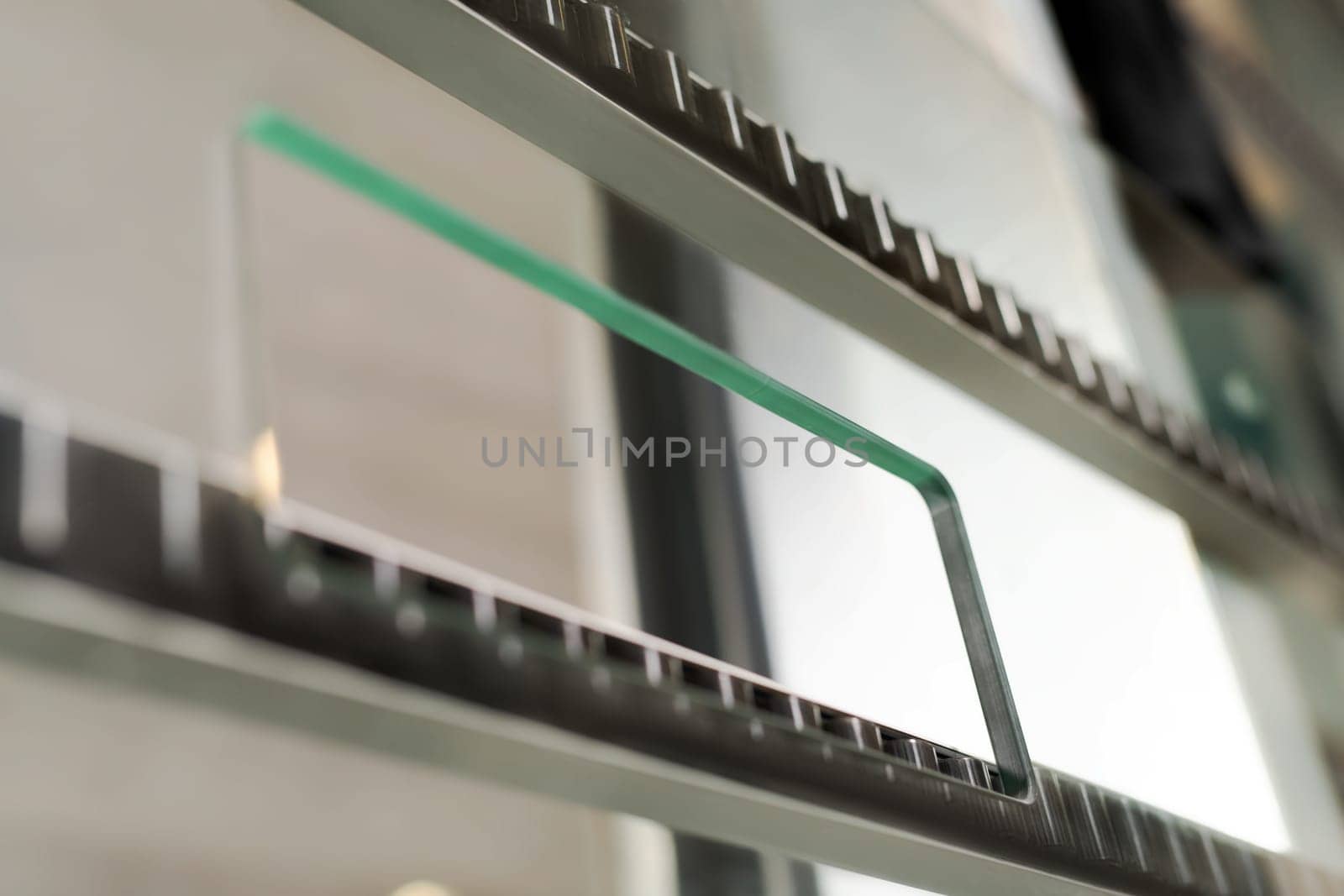 Closeup part of glass cut and polished machine with metal and plastic elements