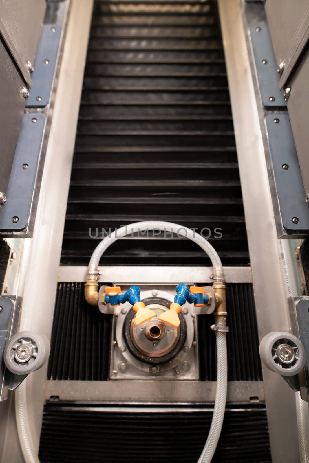 From above of professional equipment with tubes near wheels and screws over rubber elements