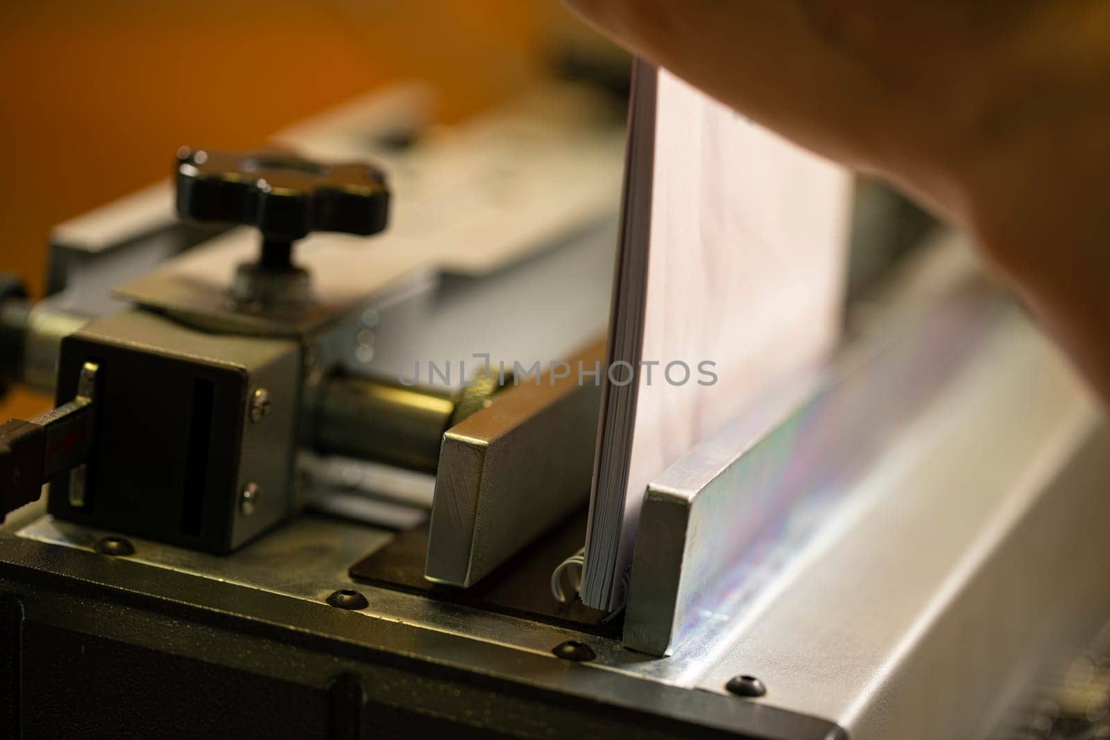 Paper spiral notepad between iron parts of professional machine tool in modern workplace