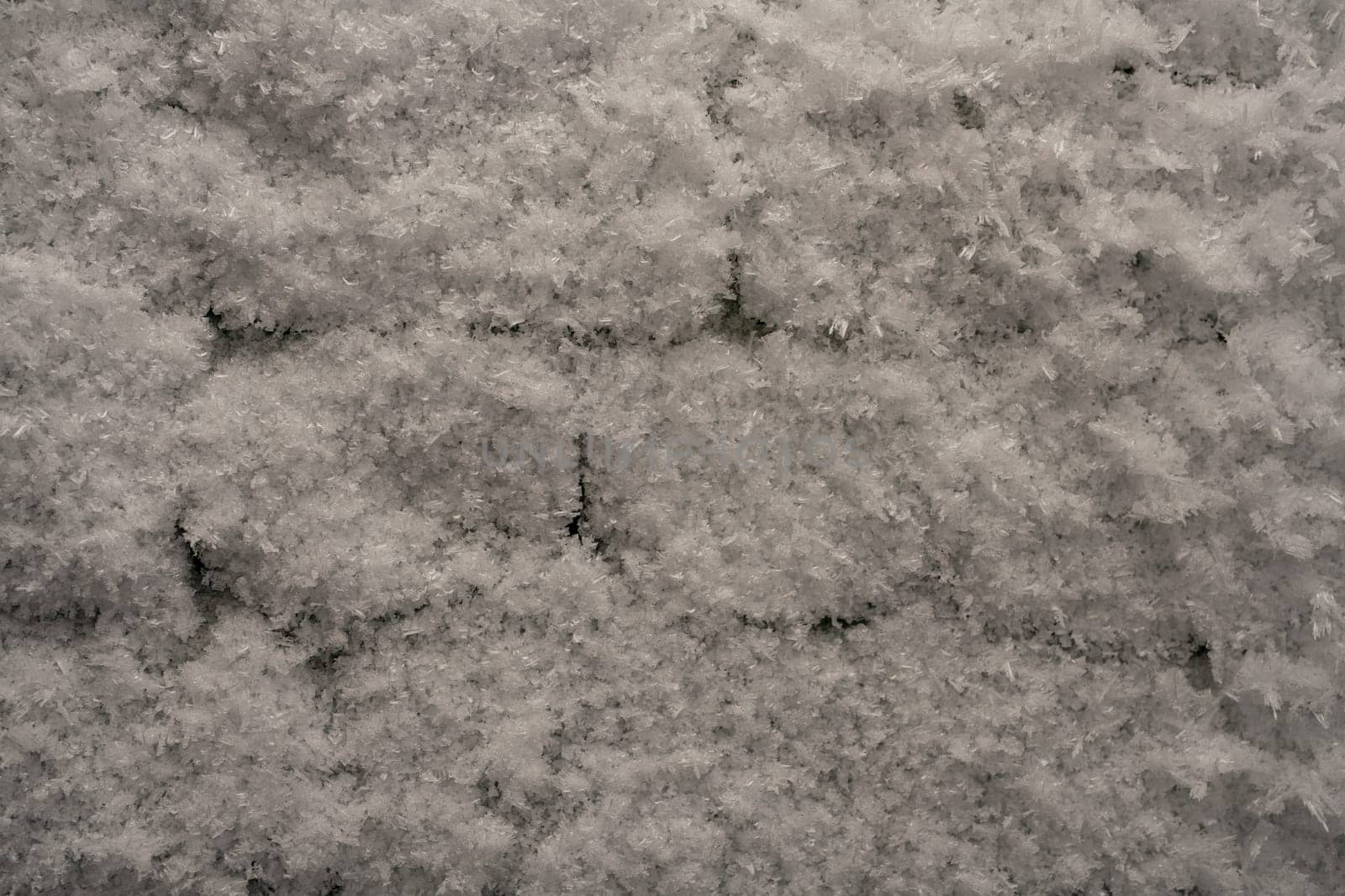 brick wall in ice and frost - cold winter concept background
