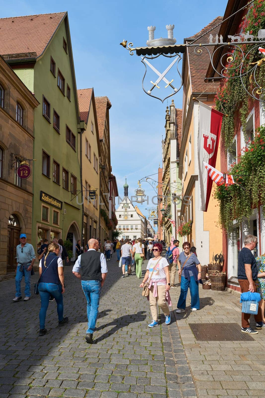 Rothenburg ob der Tauber, Germany – September 22, 2024: Tourists in the obere Schmiedgasse in the old town of Rothenburg ob der Tauber in Germany