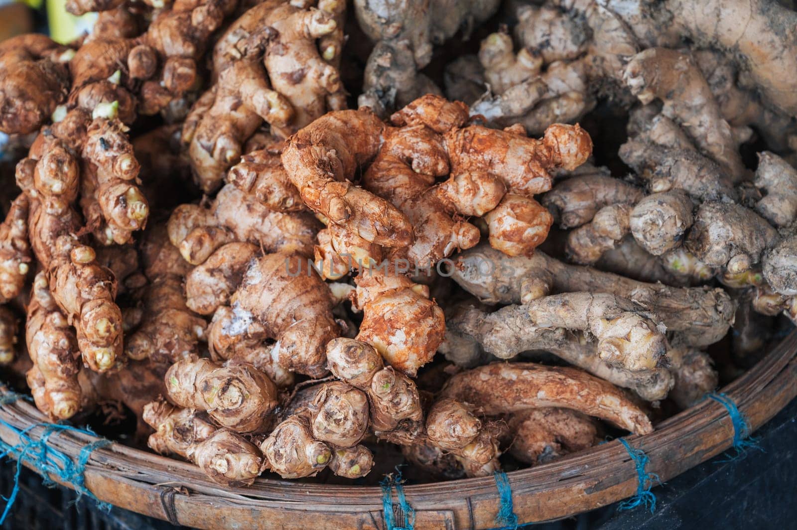 fresh ginger tubers on the counter at a street market