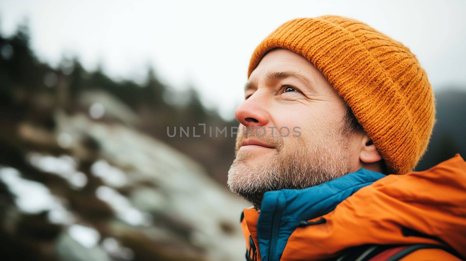Travel, hiking, adventure, close-up portrait of happy traveler hiker man in hat stands on top of mountain looking away, side view