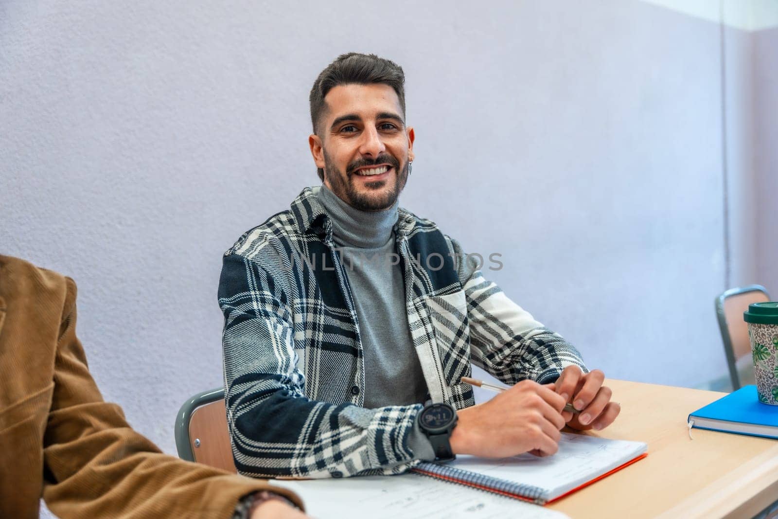 Smiling university student engaging in studying and taking notes during a lecture, immersed in learning and academic growth