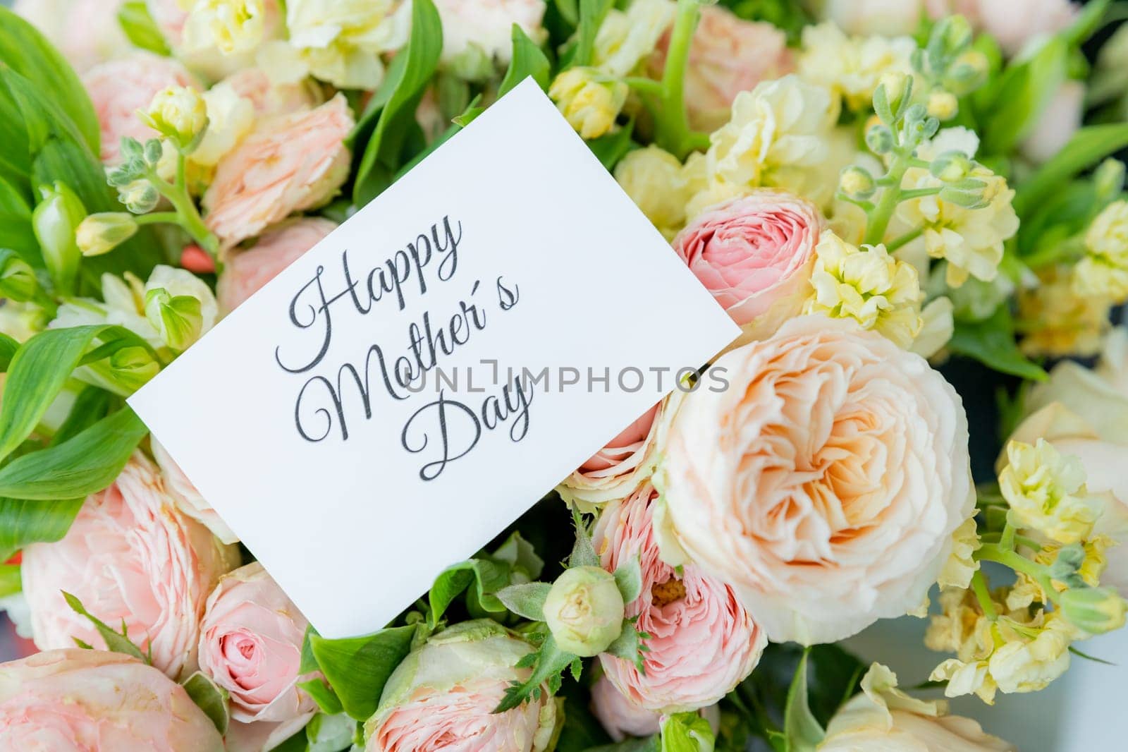 Happy Mother's Day greeting label and beautiful flowers