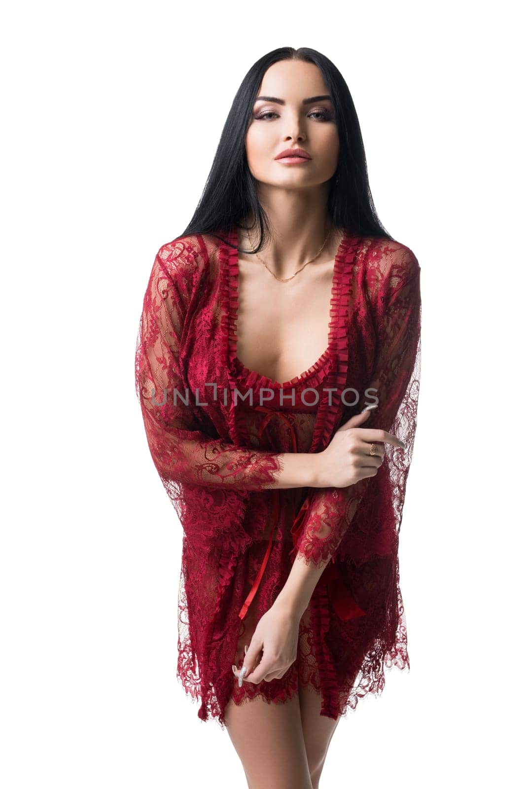 Sexy graceful female wearing red lace underwear and gown standing on white background in studio and looking at camera