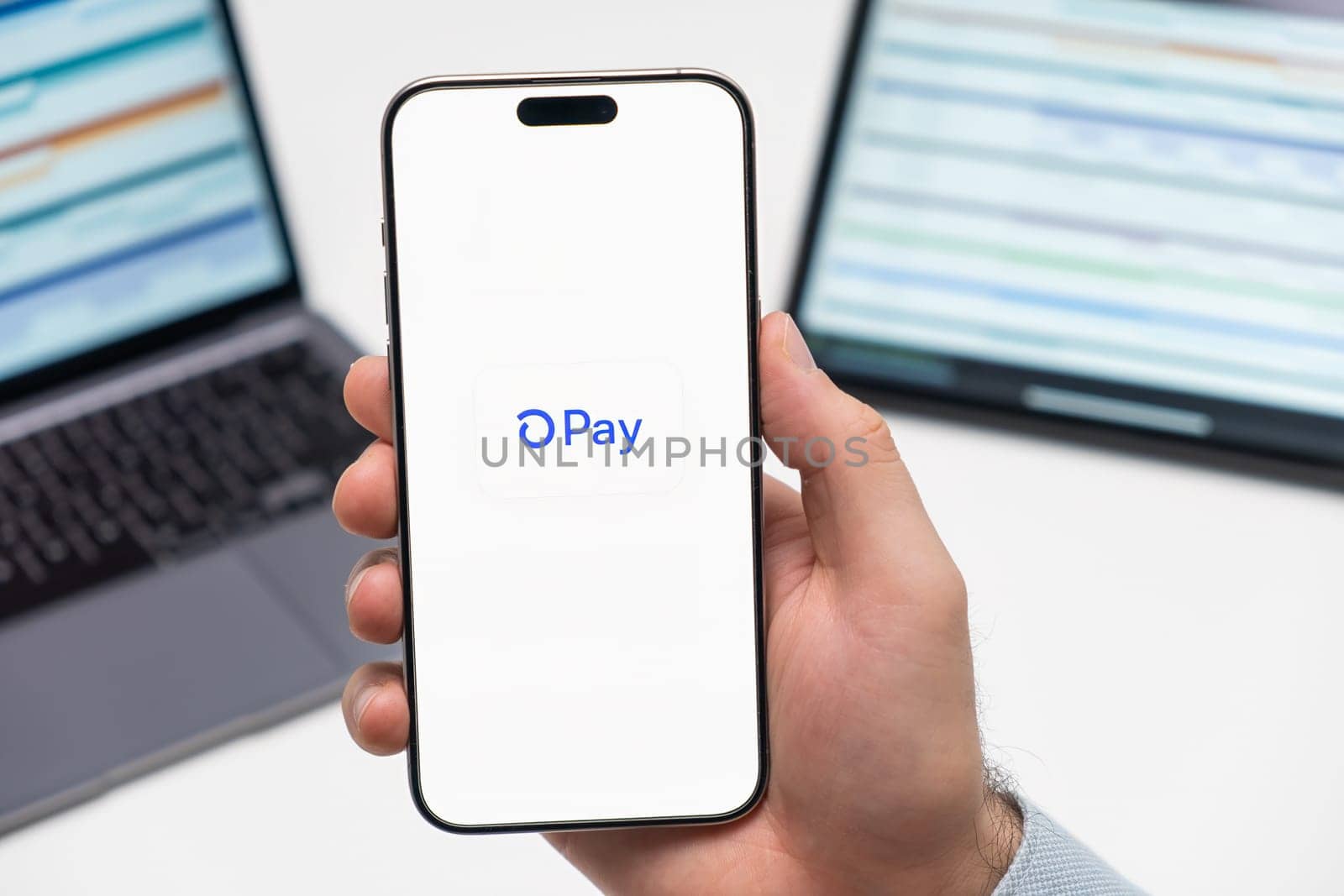 PRAGUE, CZECH REPUBLIC - JANUARY 21 2024: Pay logo on the screen of smartphone in mans hand on the workplace background.