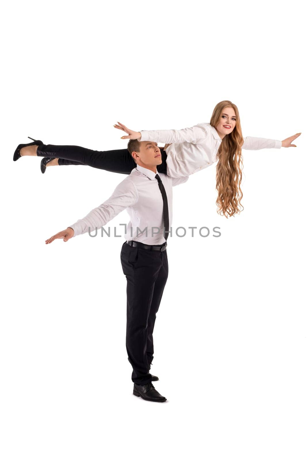 Full body side view of confident businessman carrying female partner on shoulder as concept of cooperation and trust in business