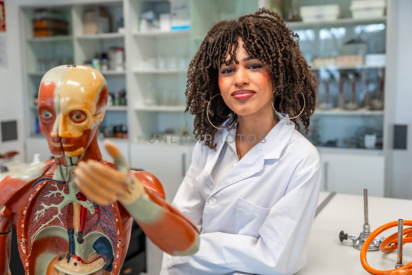 Confident medical student learning human anatomy using anatomical model in a university laboratory
