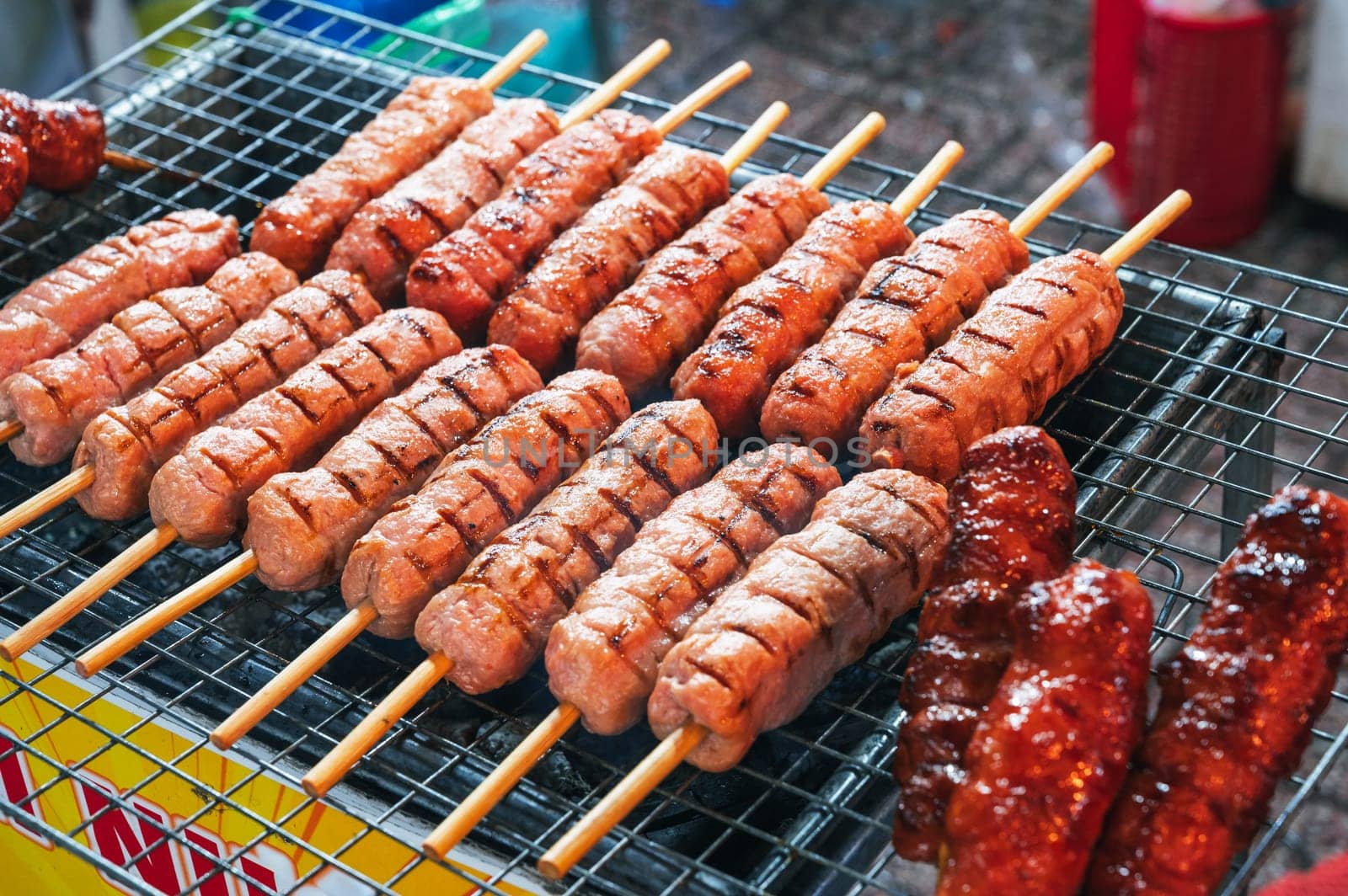 grilled sausages on sticks. Street fast food in Asia in Vietnam