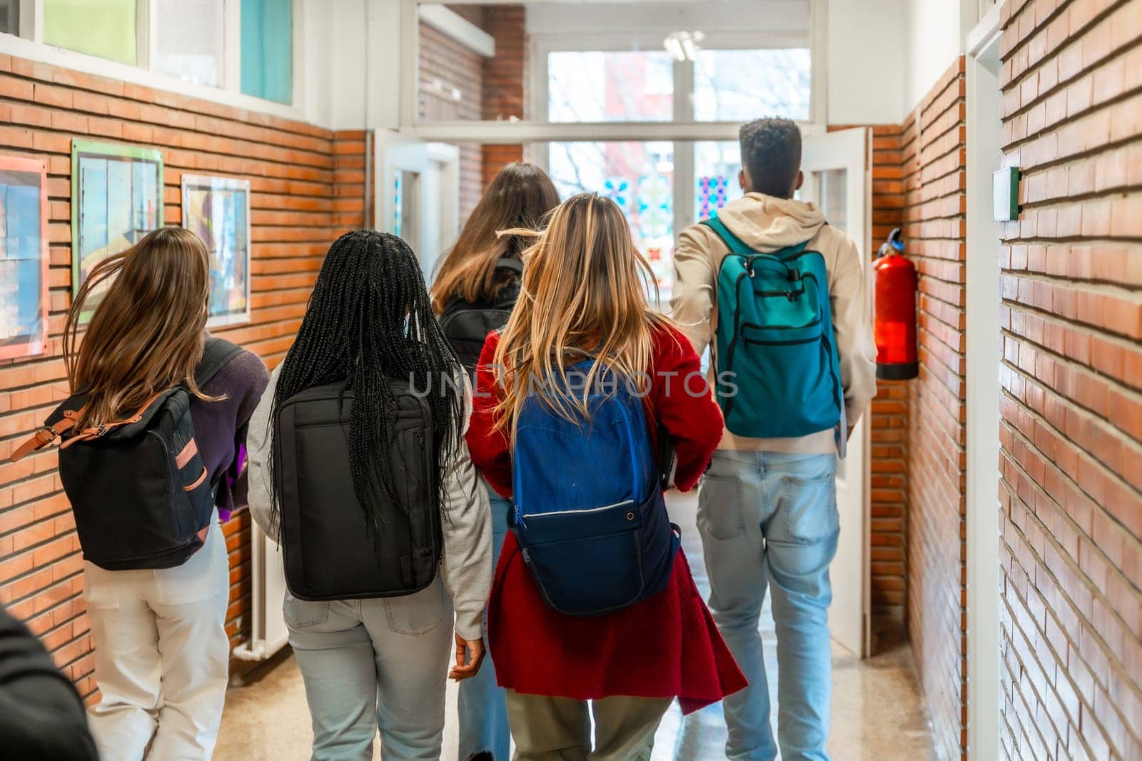 Diverse group of high school students walking together down a bustling school hallway after class, enjoying their time and friendship