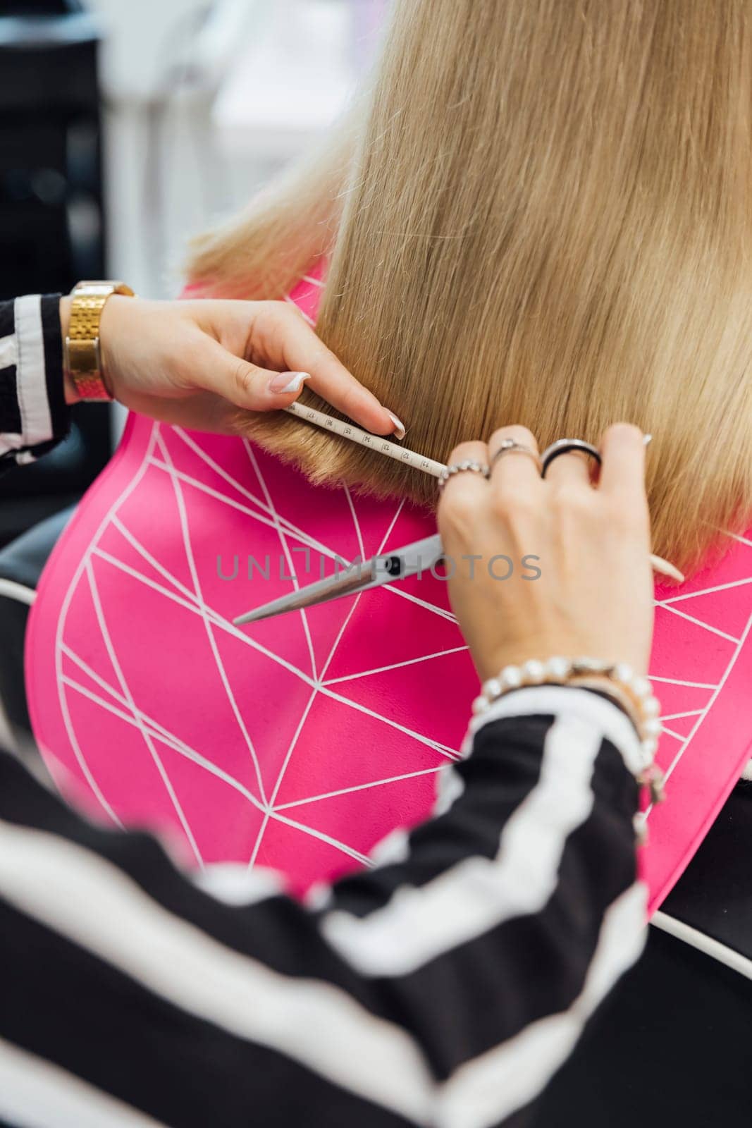 Hairstylist does a haircut styling for a woman