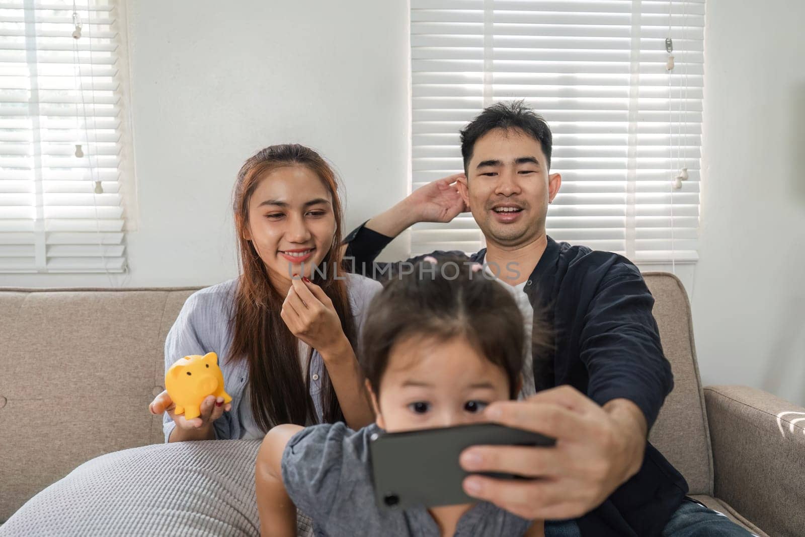 A joyful family engages in a video call, capturing moments of happiness and connection in their cozy living room.