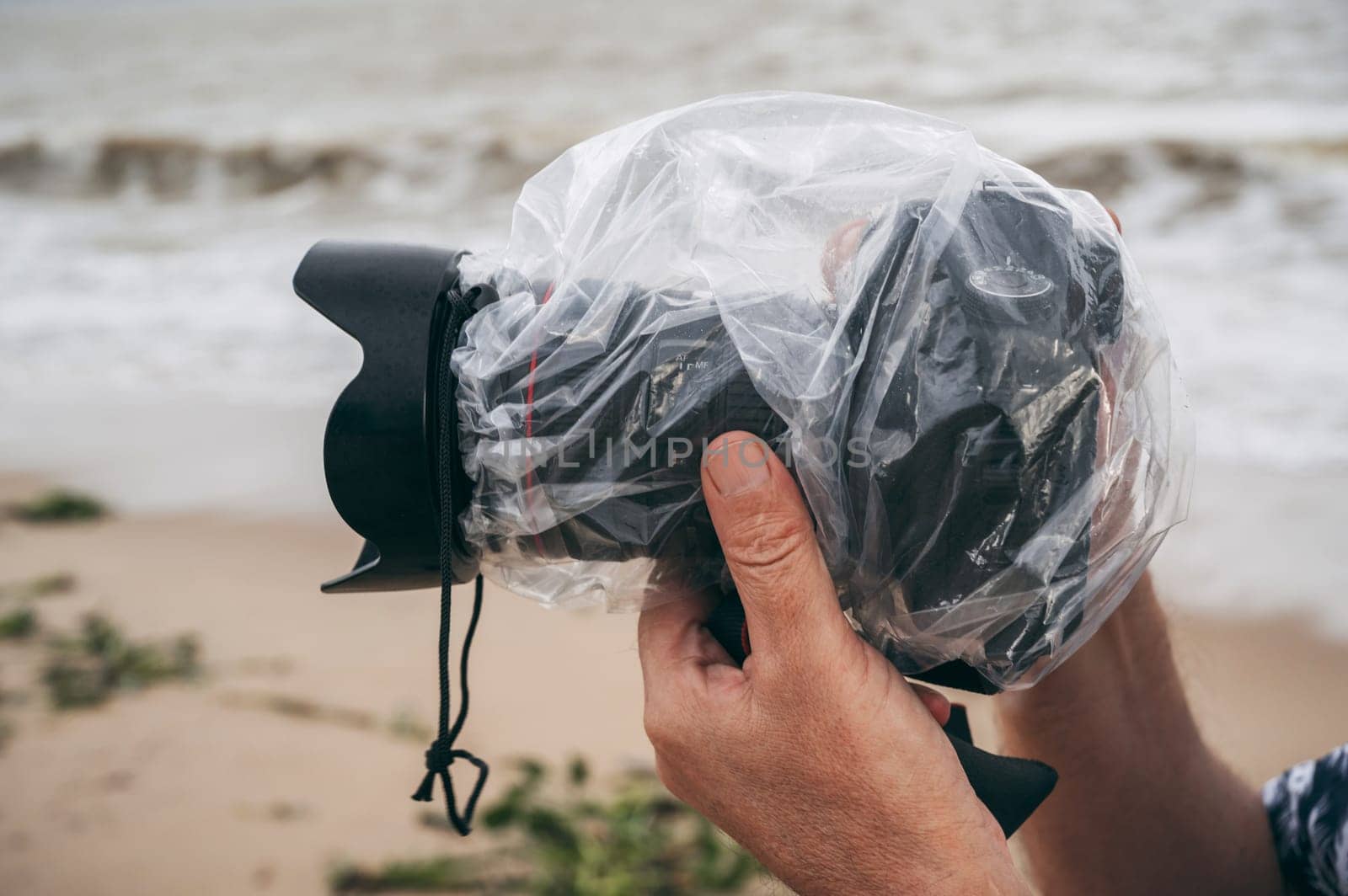 digital photo camera in a waterproof case that protects against rain and splashes in nature on a rainy day