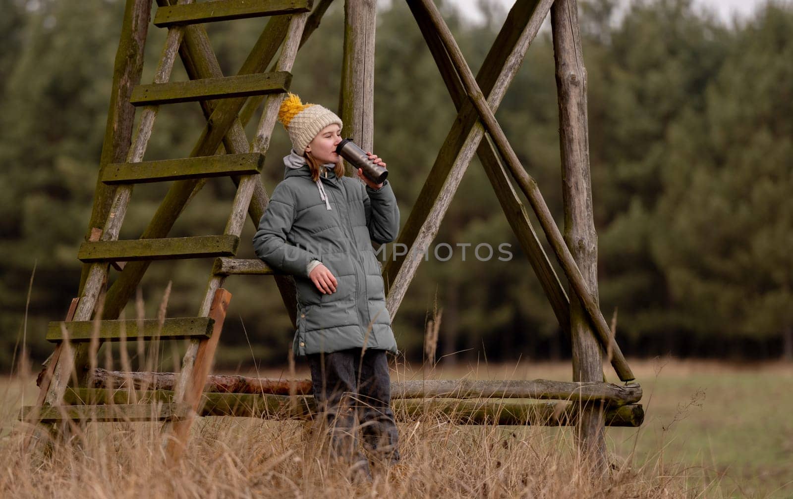 Teen Girls With A Thermos In Spring Near The Watchtower In The Forest