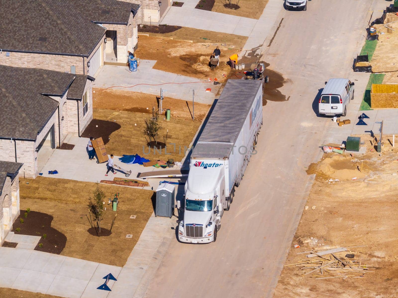 Georgetown, TX - 25 February 2025: Moving truck unloading boxes into newly constructed home in Sun City