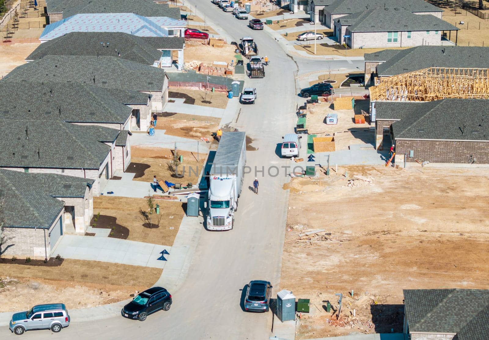 Georgetown, TX - 25 February 2025: Moving truck unloading boxes into newly constructed home in Sun City