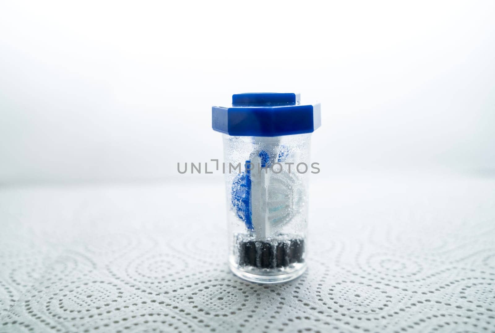 close-up of a container for cleaning and storing contact lenses for the eyes, used at home. For soft and hard lenses. in the container there is an active cleaning process, bubbles are released.