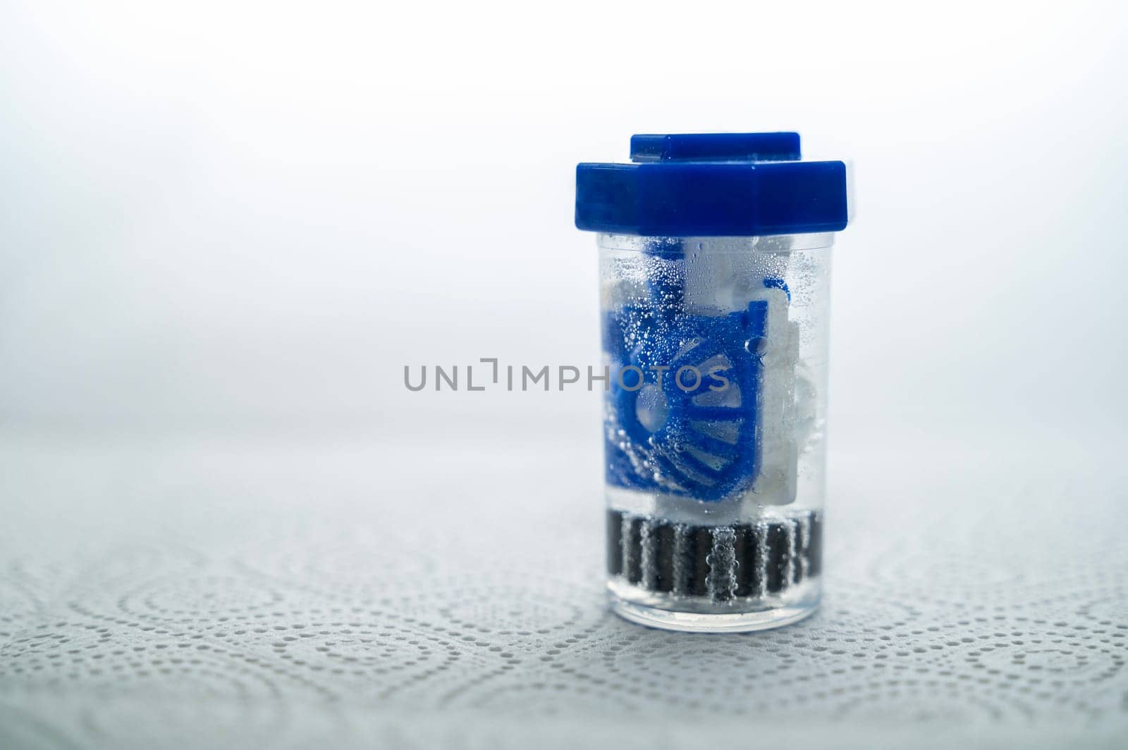 close-up of a container for cleaning and storing contact lenses for the eyes. used at home. For soft and hard lenses. in the container there is an active cleaning process, bubbles are released.