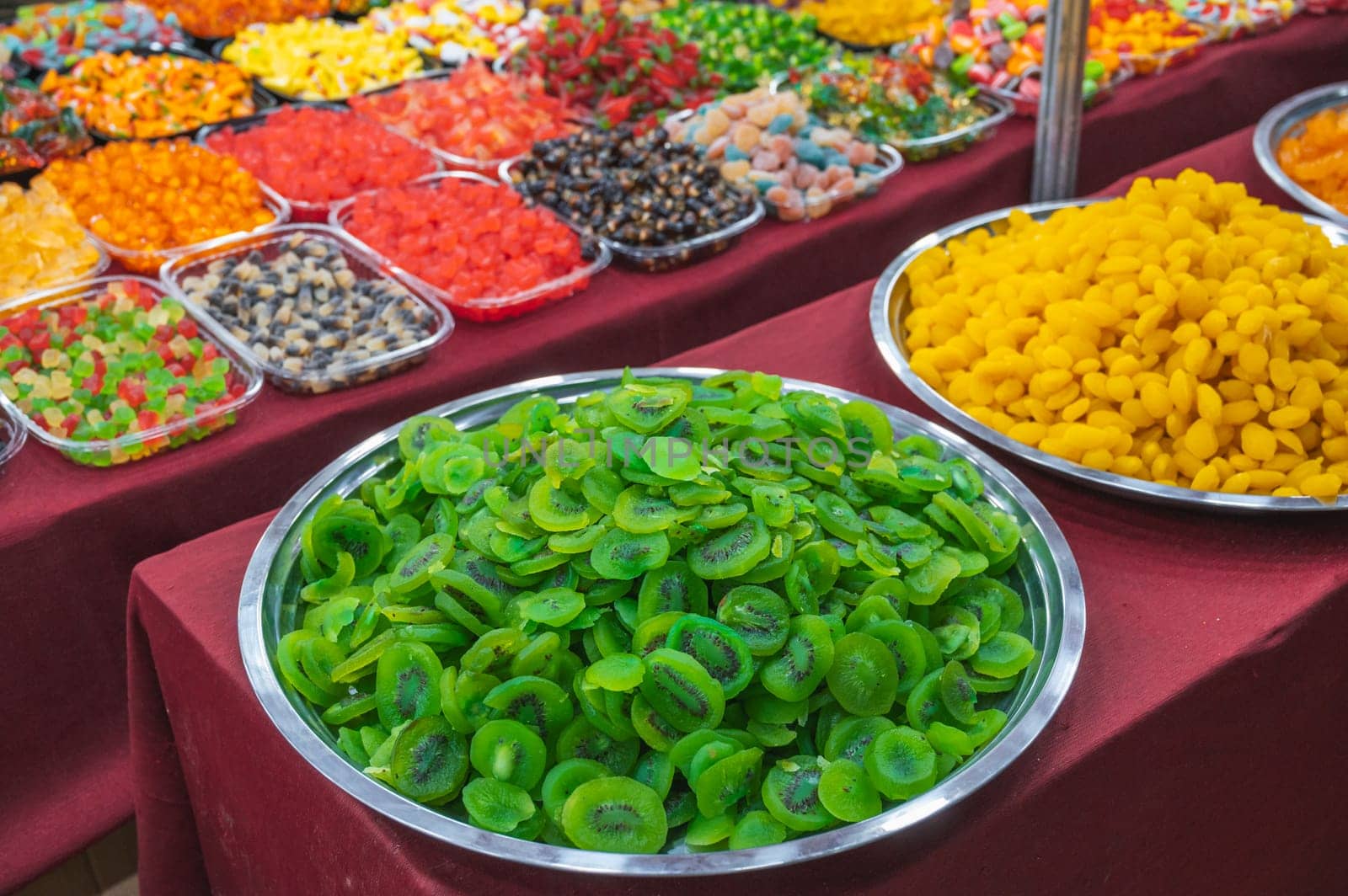 Green slices of dried kiwi. assortment of dried fruits and sweets on the oriental market