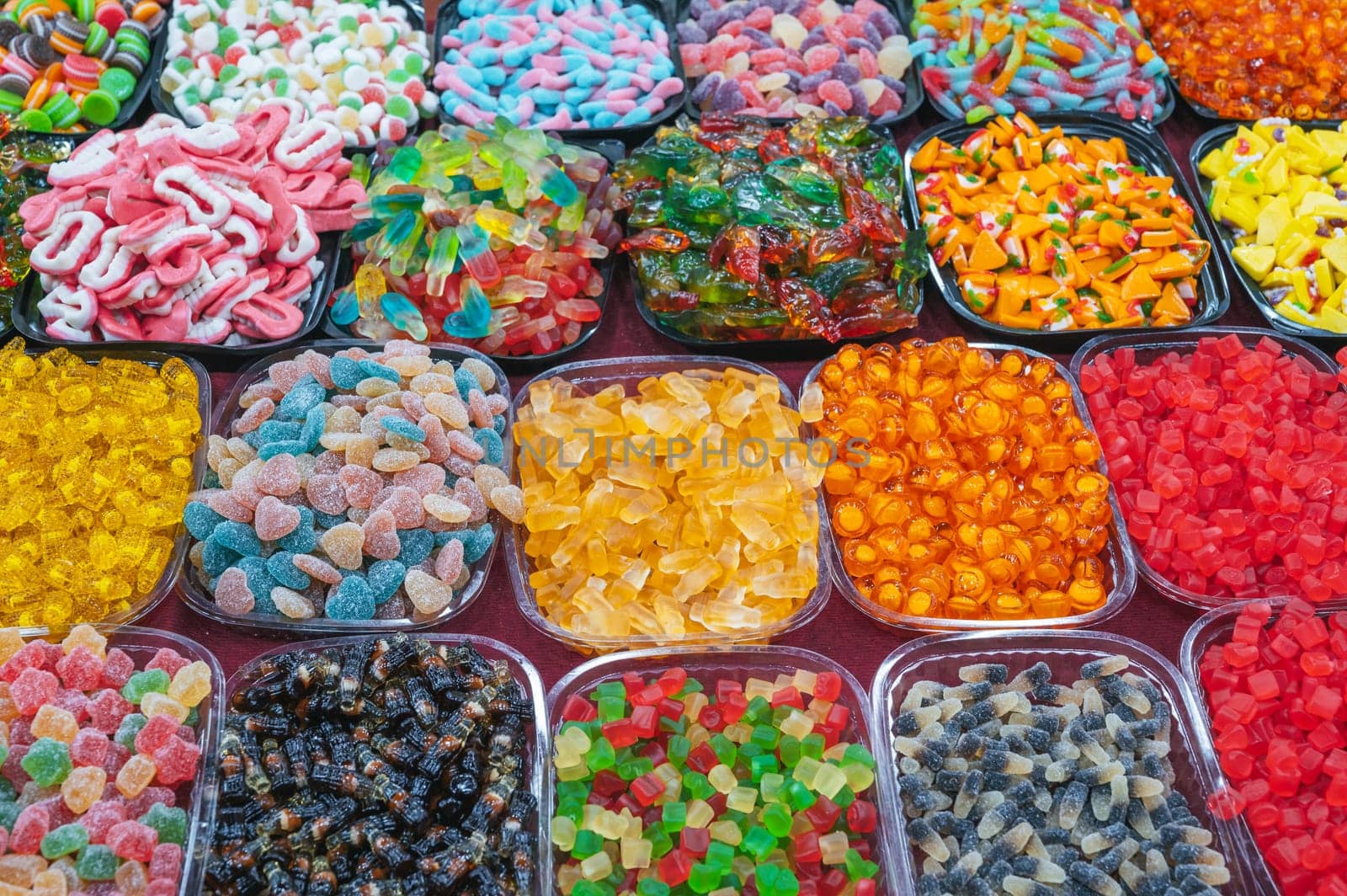 assortment of colorful marmalade and chewable candies on the counter at a candy store in the oriental market