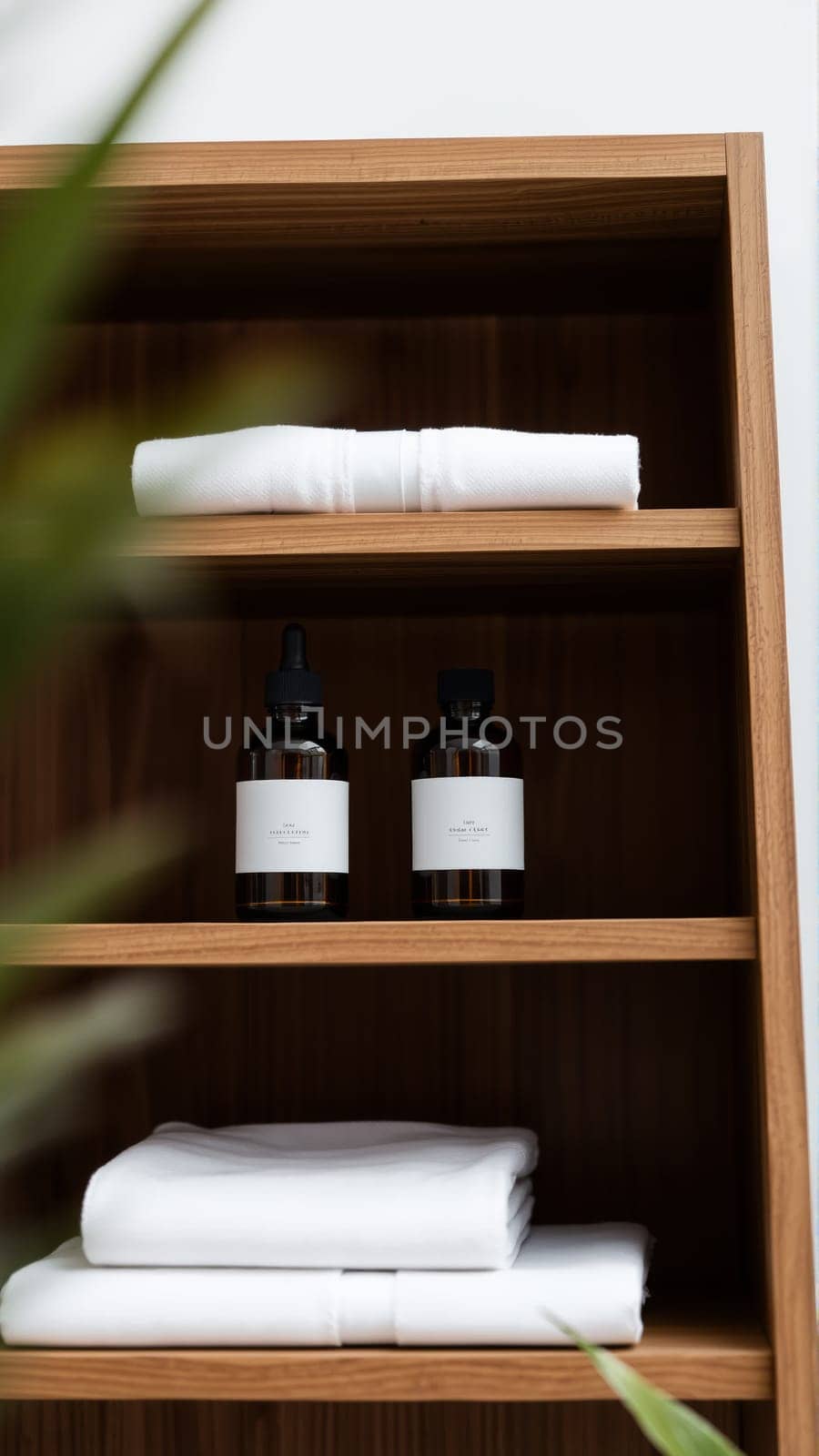 Spa treatment set, wooden shelf with neatly folded towels and dispensers for soap, cream, massage oil. High quality photo