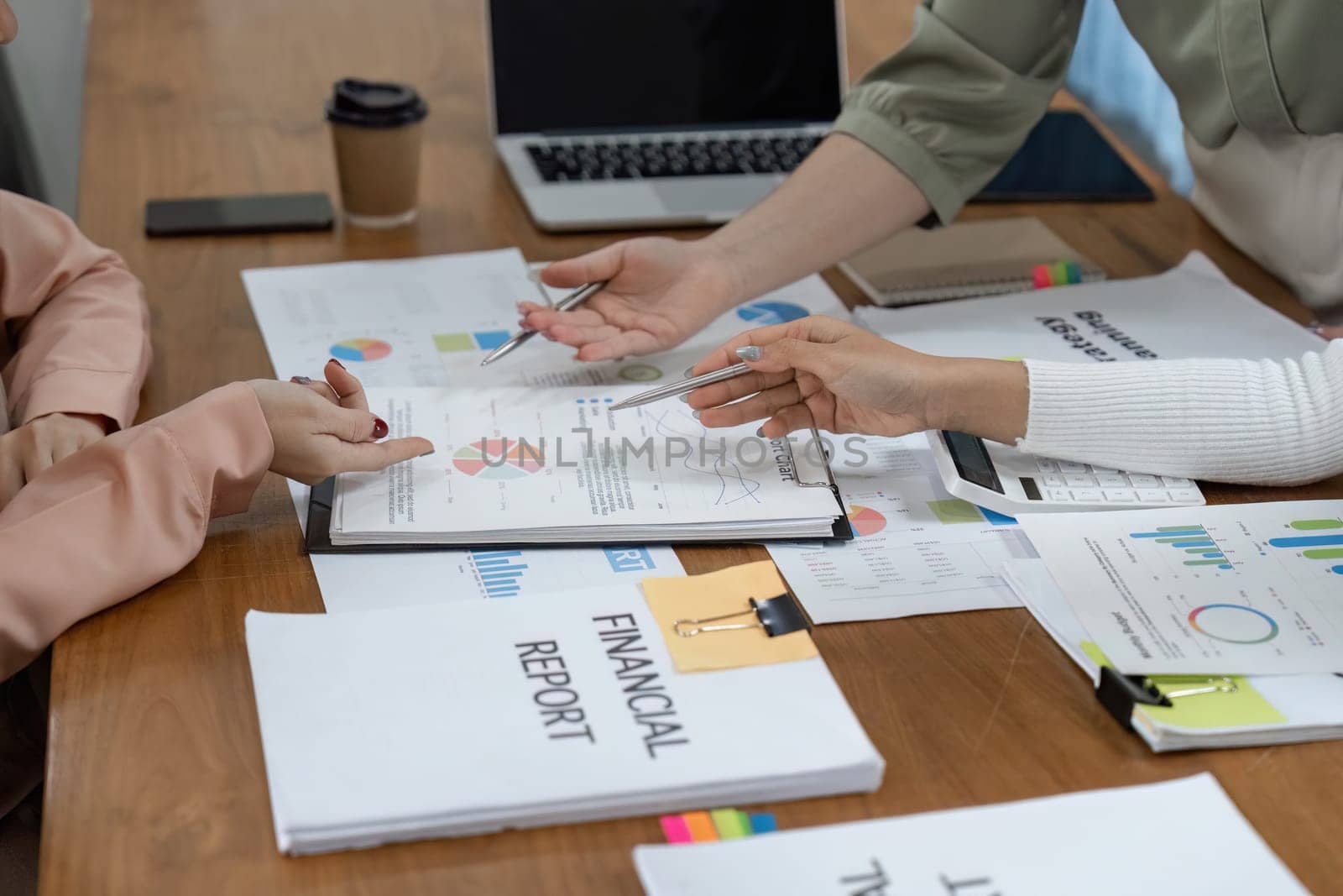 A diverse group of women financial experts presents budget strategies and discusses financial reports in a contemporary office.