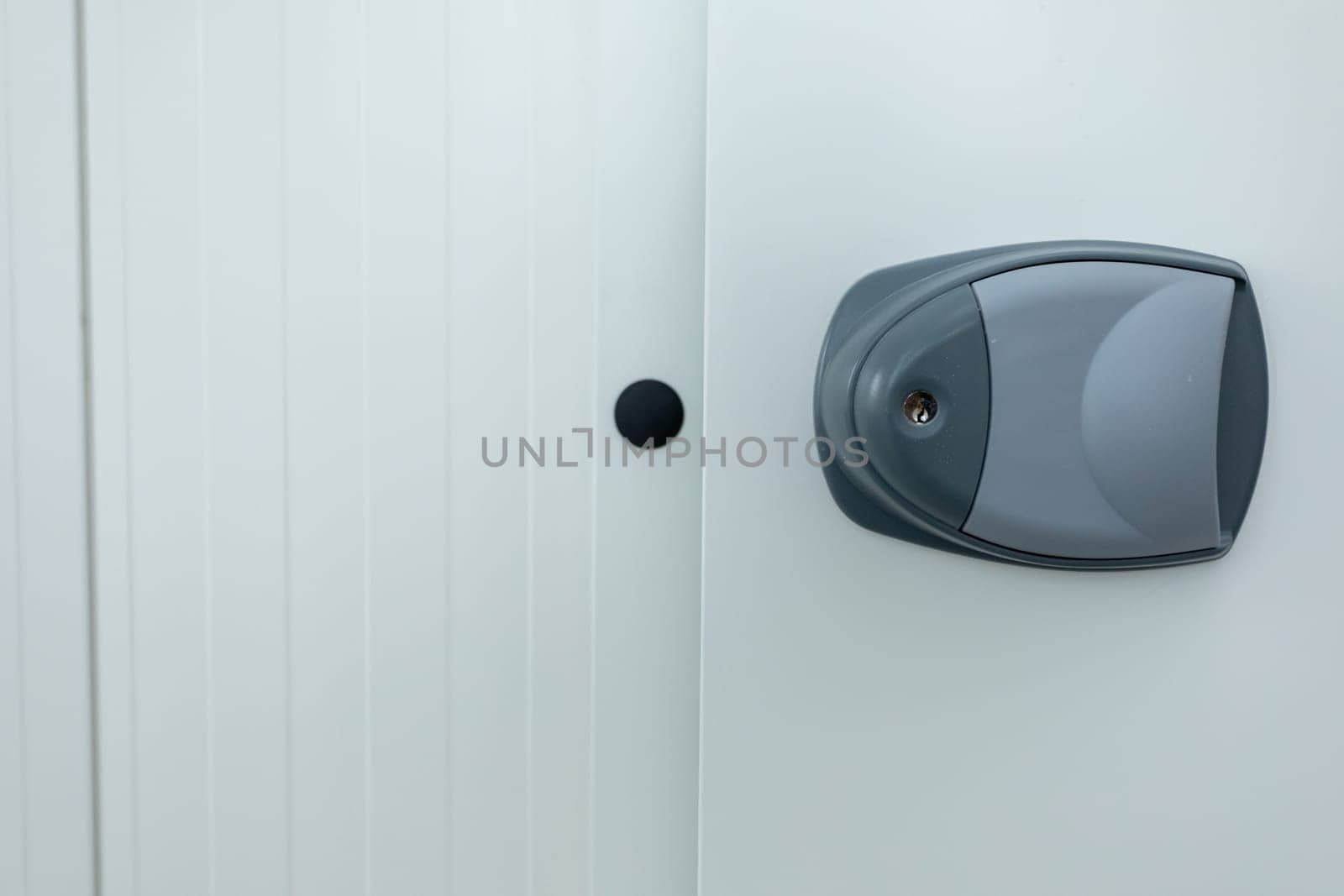 A sleek, stylish lock on a pristine, clean white door perfectly symbolizes both security and modern design aesthetics
